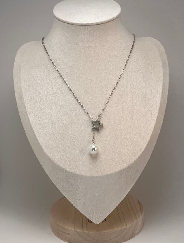 Sterling Silver CZ Star and White Pearl Drop Necklace: Marked S925, this modern necklace features a delicate chain suspending an open-back star pendant set with sparkling cubic zirconia. A luminous white pearl drop adds a touch of elegance and movement. T