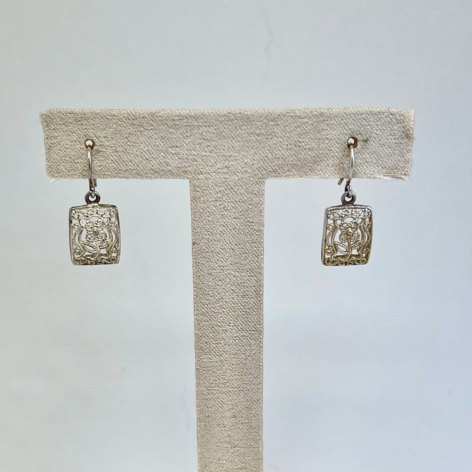 Sunstone Imports Sterling Silver Carved Rose Flower Design Dangle Earrings: A charming pair of vintage dangle earrings by Sunstone Imports, finely mancrafted in sterling silver made in Thailan. Each earring showcases a delicately carved openwork rose motif framed within a sof