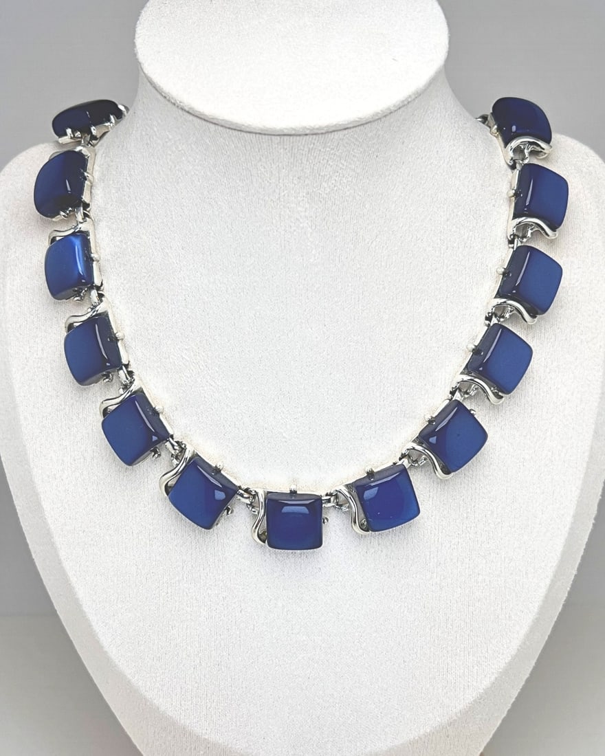 Vintage CORO Cobalt Blue Thermoset Necklace with Silver-Tone Settings: Elegant mid-century necklace by Coro, crafted in the 1950s, featuring rich cobalt blue thermoset plastic inserts set in sculptural silver-tone metal frames. The articulated construction offers gracefu