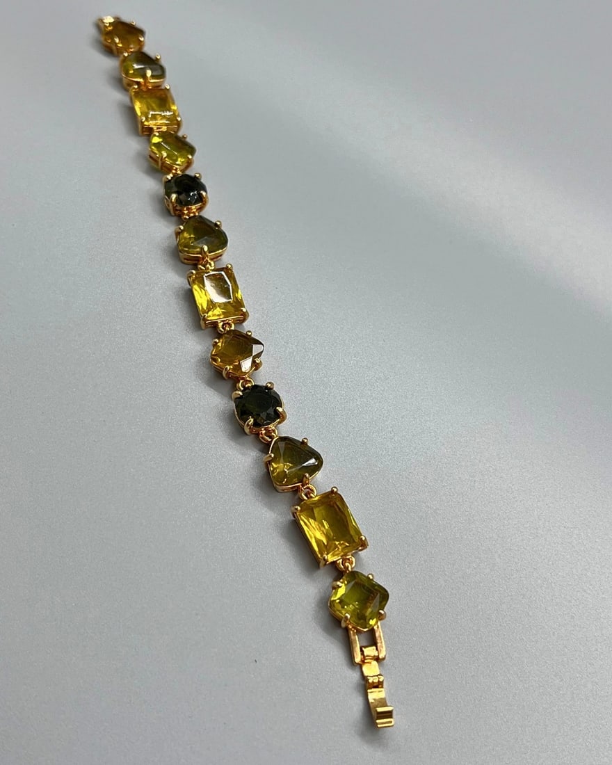 Monet Signed Yellow Glass Link Bracelet, Faceted Stones in Gold Tone: This vintage Monet link bracelet features a series of prong-set and bezel-set faceted glass stones in shades of yellow, golden amber, and olive green. Each stone is uniquely shaped—ranging from emer