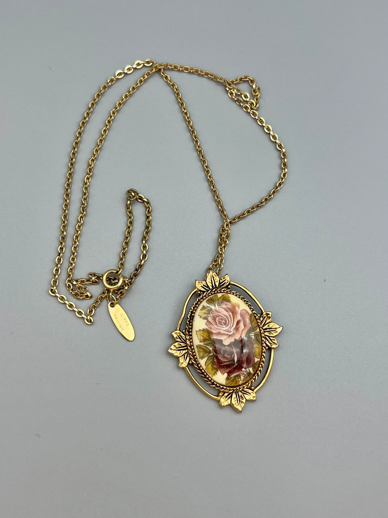Vintage Sarah Coventry Floral Ceramic Pendant with Whiting Davis Chain: This vintage necklace showcases a romantic floral pendant by Sarah Coventry, featuring a glazed ceramic cabochon with a delicate rose print in soft pink and burgundy tones. The ceramic piece is framed