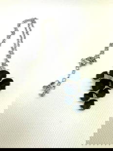 Abstract Circular Pendant Silver-Tone Necklace: This silver-tone necklace features an abstract pendant composed of seven irregular circular elements joined together. The front side showcases a black enamel-like texture within silver metal rims, cre