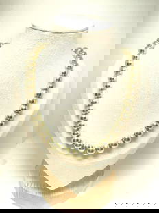 Vintage Silvertone Bead Necklace: This is a vintage silvertone bead necklace featuring a string of evenly sized, smooth, and glossy round beads. It comes with an adjustable chain and clasp, allowing for flexible length fitting. The de
