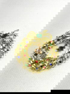 Vintage Christmas Wreath Brooch with Multicolor Rhinestones: This brooch features a classic Christmas wreath design, adorned with small red, blue, and green rhinestones. A tiny copper-tone bell dangles at the center, adding playful movement. The top is accented
