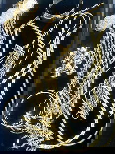 Gold-Tone Vintage Mixed Jewelry Lot: This lot includes a variety of gold-tone jewelry pieces, such as embossed coin fringe necklaces, wide cuff bracelets, snake chains, flat curb chains, chunky bead bracelets, thin bangles, and beaded ta