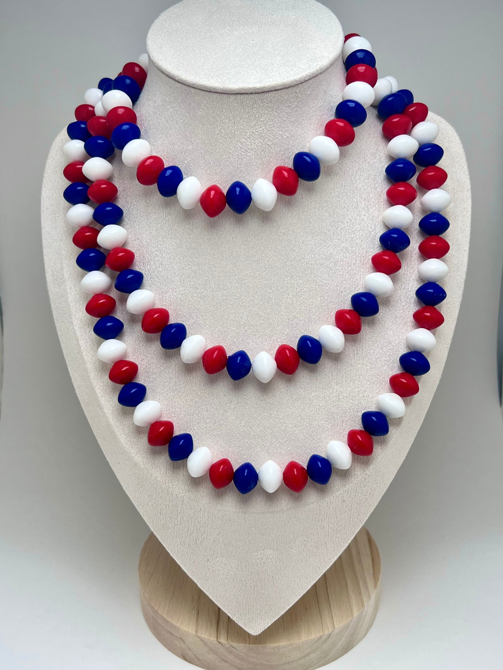 Vintage Crown Trifari Red White Blue Beaded Opera Length Necklace: Classic vintage beaded necklace by Crown Trifari, featuring vibrant red, white, and blue acrylic beads in a playful and bold color combination. The opera length allows it to be worn long or doubled fo