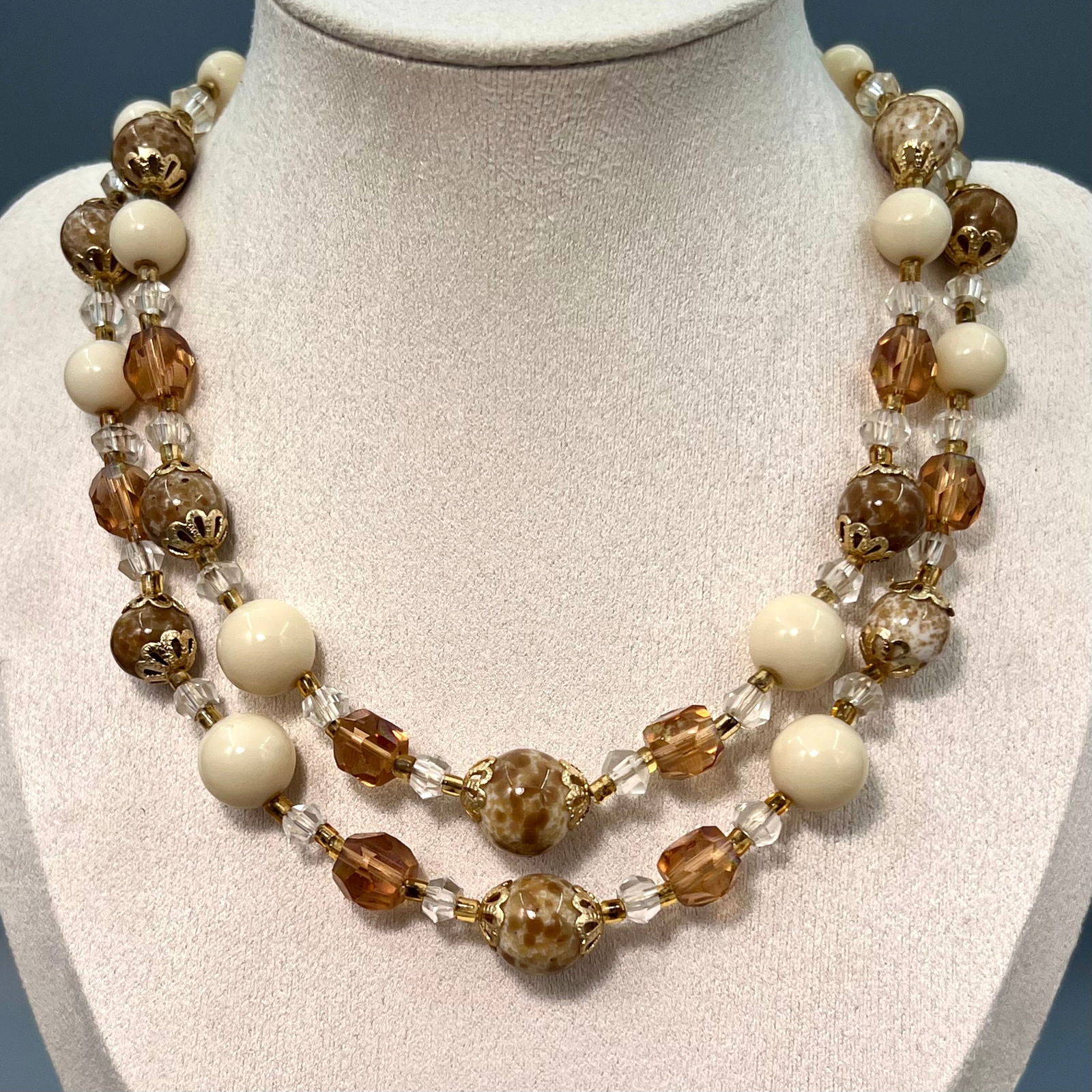Vintage Japan Double Strand Glass Bead Necklace: Marked Japan on the clasp, with cream white glass beads, marbled brown beads, and faceted amber spacers. The white beads fluoresce under UV light, typical of mid-century Japanese export jewelry, c.195