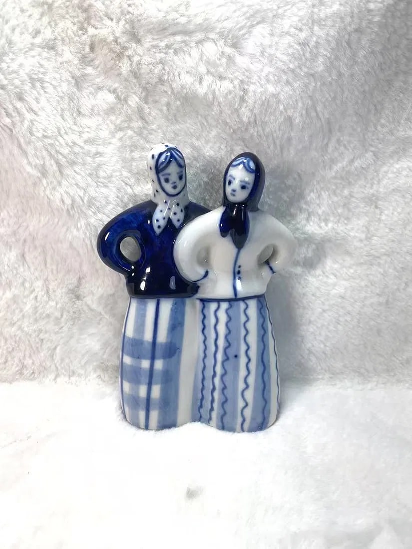 Vintage USSR Gzhel Porcelain Figurine _ Two Women in Blue and White Folk Dress, Hand-Painted: A charming vintage porcelain figurine hand-painted in the traditional Gzhel blue-and-white palette, depicting two women in folk costumes standing side by side with hands on hips. Made in the USSR and 