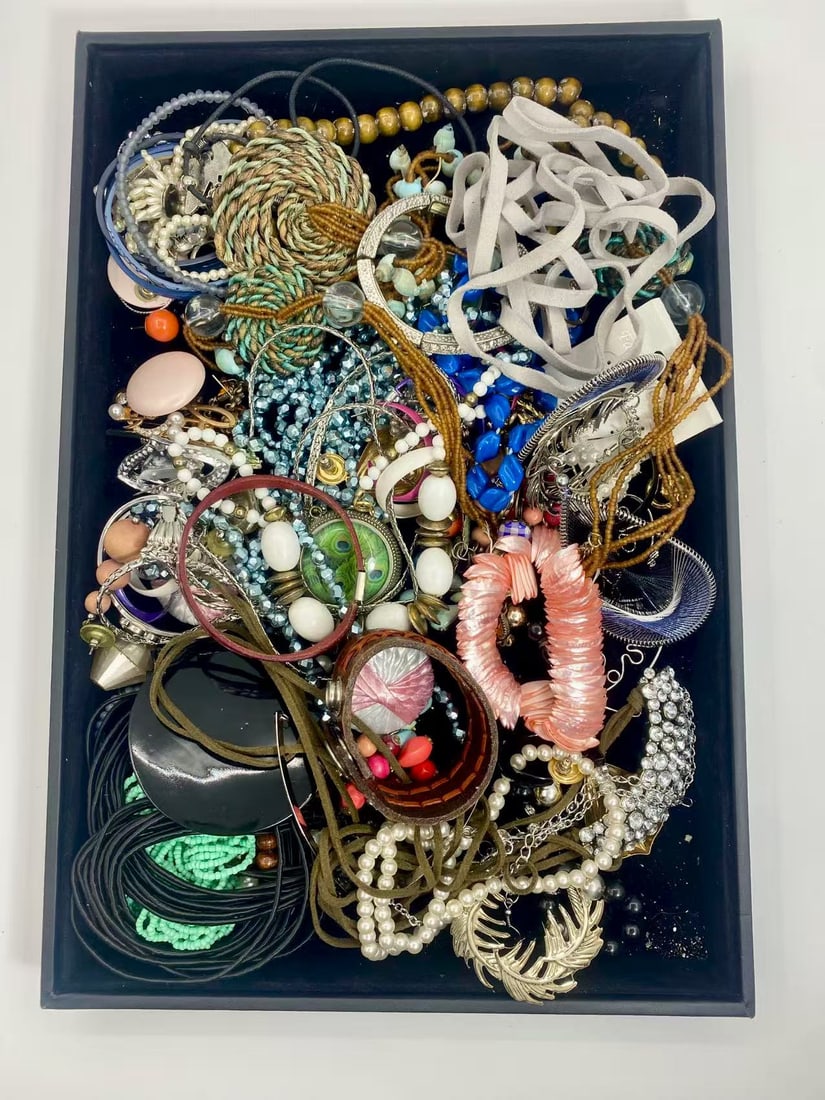 1 LB Unserached Jewelry Lot (As-Is, Tray Not Included): Assorted costume jewelry lot including necklaces, bracelets, earrings, pendants, and beaded pieces in various materials and styles. Contents are unsearched, unexamined, and untested, and are sold as-i