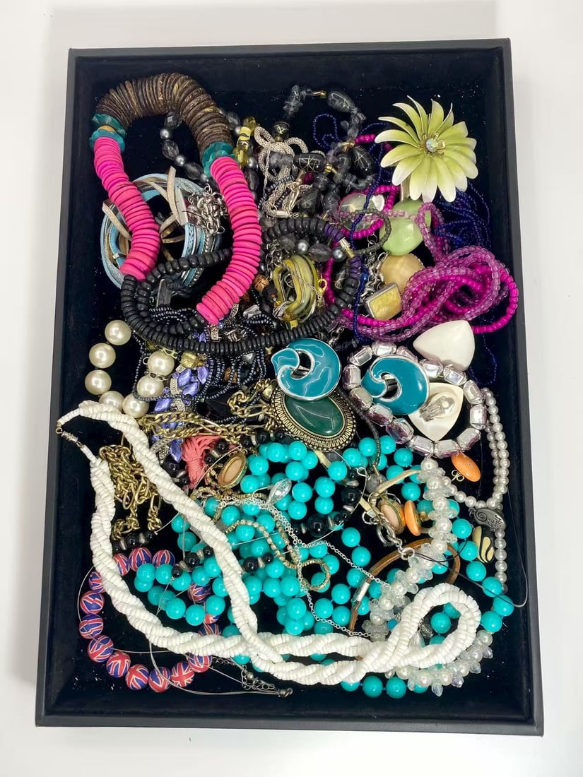 1 LB Unserached Jewelry Lot (As-Is, Tray Not Included): Assorted jewelry lot including necklaces, bracelets, earrings, pendants, and beaded pieces in various materials and styles. Contents are unsearched, unexamined, and untested, and are sold as-is. Items