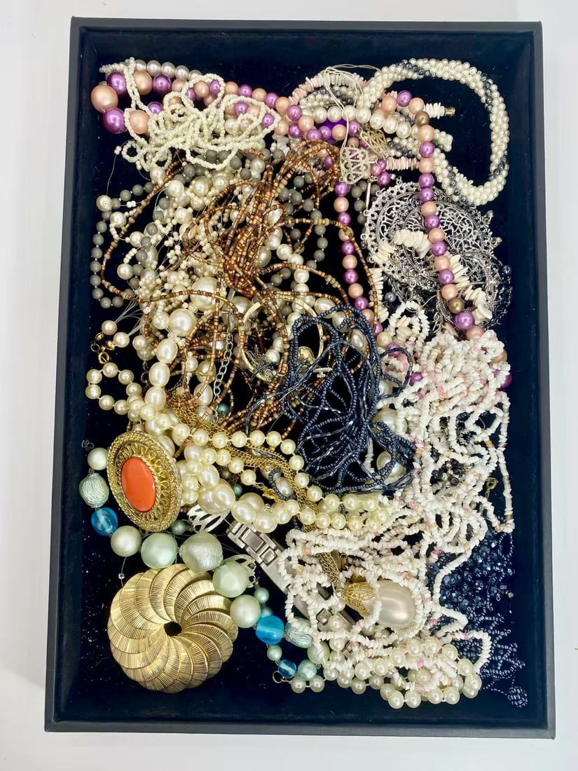 1 LB Unserached Jewelry Lot (As-Is, Tray Not Included): Assorted costume jewelry lot including necklaces, bracelets, earrings, pendants, and beaded pieces in various materials and styles. Contents are unsearched, unexamined, and untested, and are sold as-i