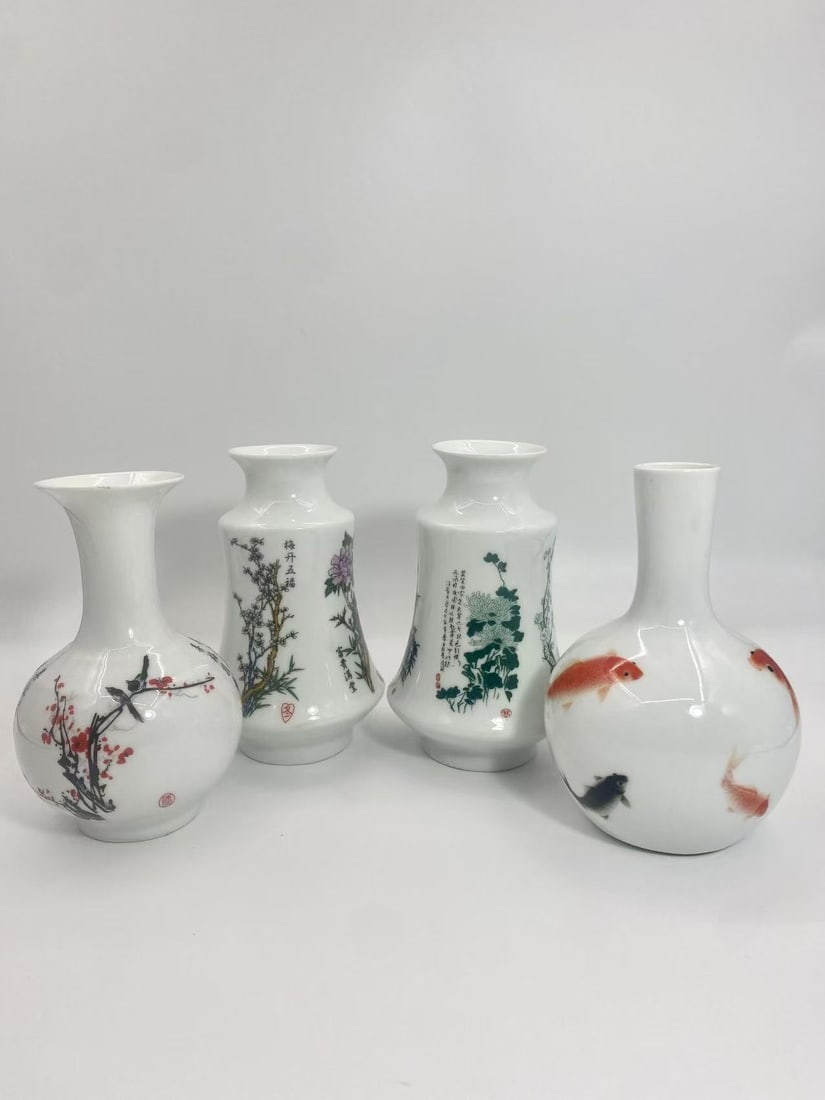 Set of 4 Chinese Hand-Painted Porcelain Vases _ Floral, Fish & Calligraphy Designs: This lot includes a set of four Chinese-style porcelain vases, finely hand-painted with traditional motifs such as plum blossoms with birds, peonies, chrysanthemums, and goldfish. Some vases also feat
