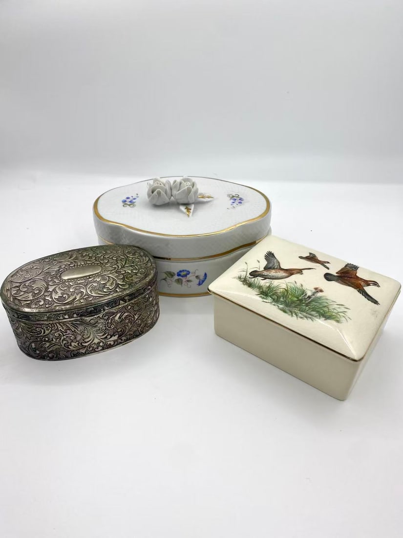 Vintage Decorative Box Lot _ Metal & Ceramic (3 Pieces): This lot includes three vintage decorative boxes in both metal and ceramic, showcasing a variety of craftsmanship and styles. The group features embossed floral metalwork, English Sandland Ware cerami
