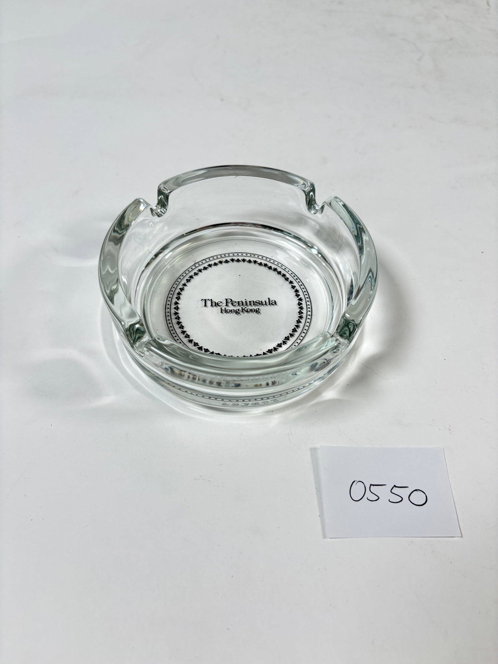 Vintage The Peninsula Hong Kong Clear Glass Ashtray: Collectible vintage clear glass ashtray from The Peninsula Hong Kong. This piece features the iconic hotel logo and showcases a classic, timeless design. A perfect addition to any ashtray collection o