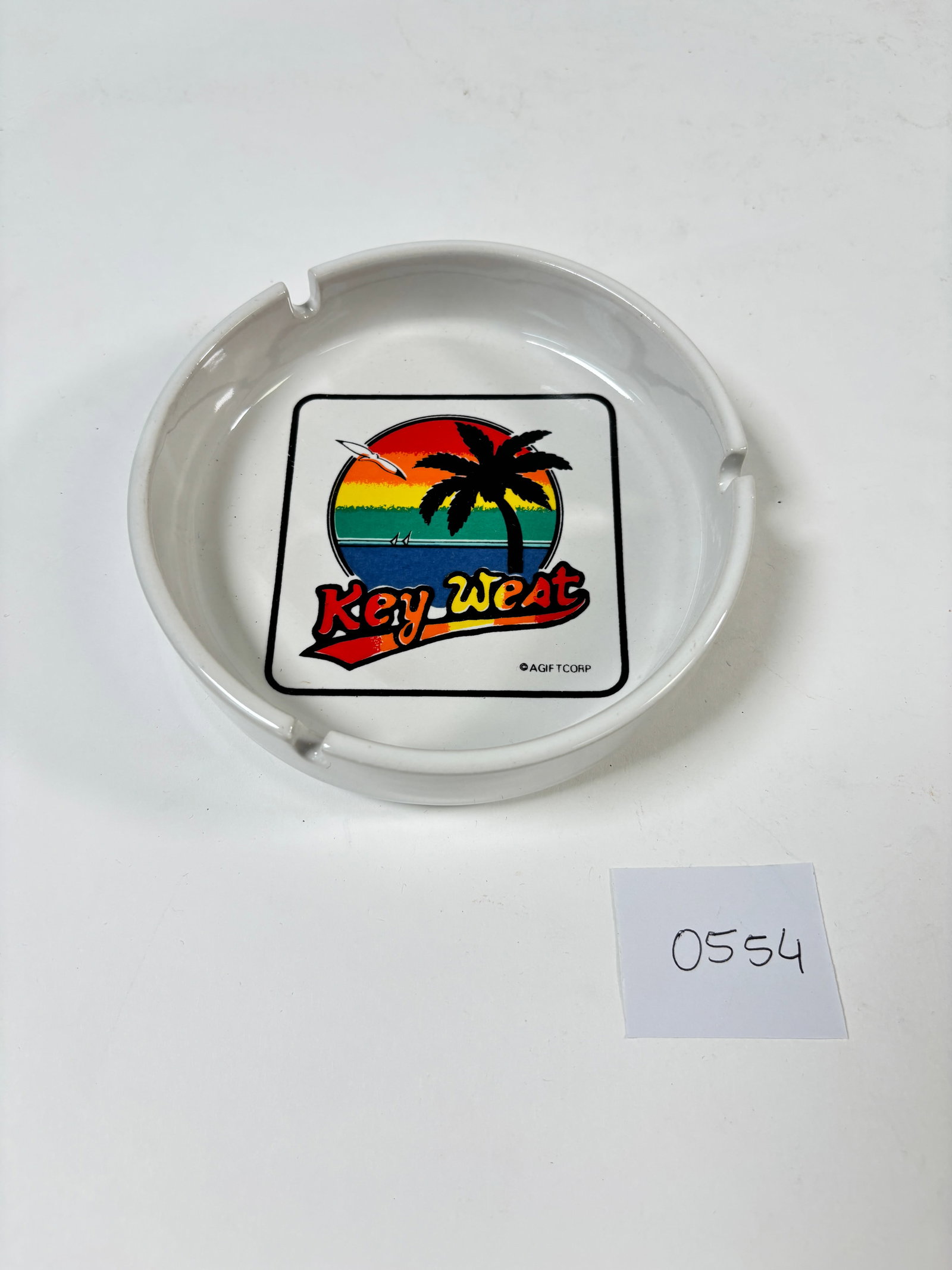 Vintage Key West Souvenir Porceline Ashtray: This vintage porcelain ashtray is a delightful souvenir from Key West. Featuring a classic design with vibrant detailing, it serves as a charming piece of memorabilia. Perfect for collectors or as a n