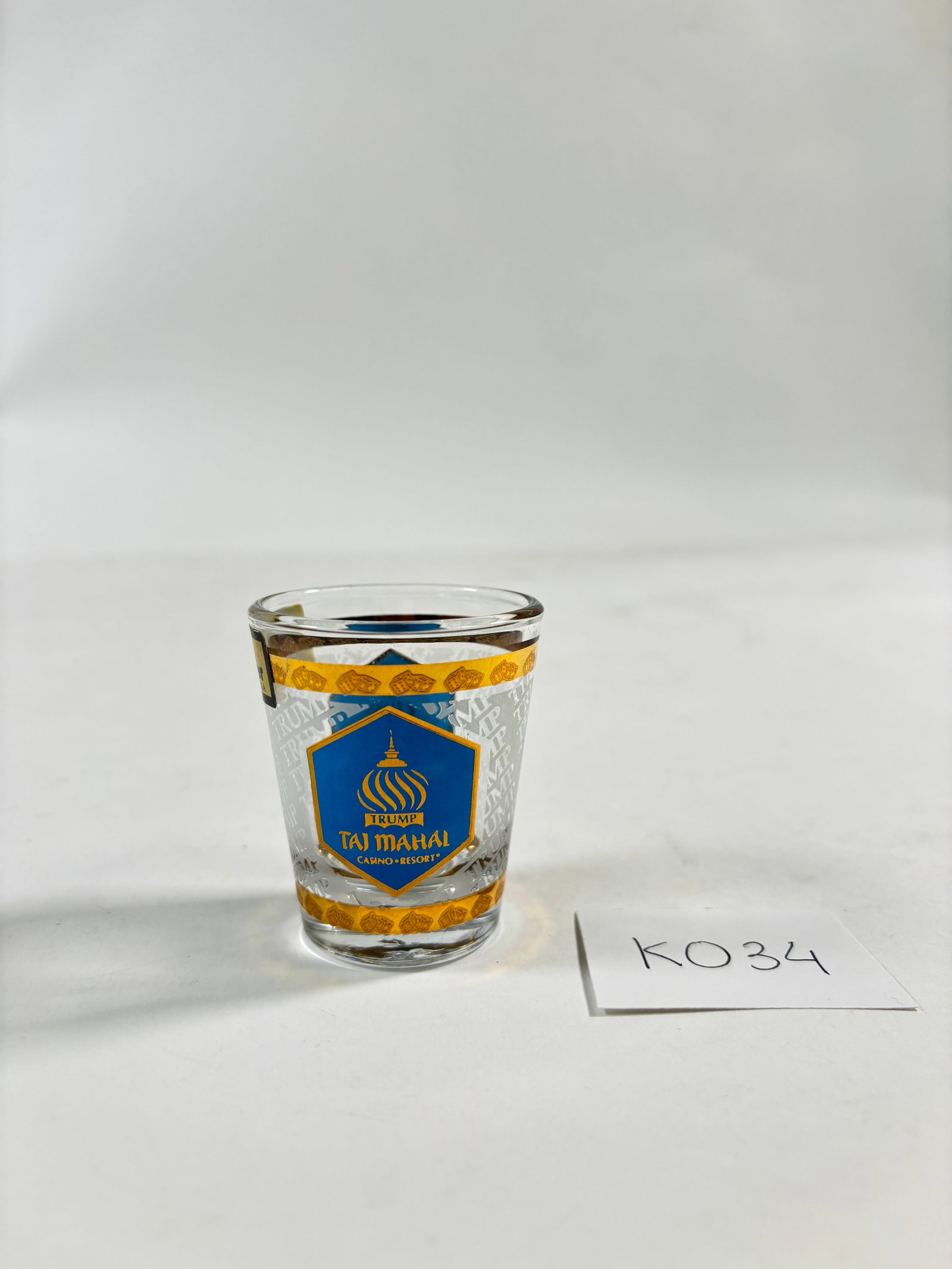 Vintage Donald Trump Taj Mahal Casino Resort Short Shot Glass with 22k Gold Detail: Vintage Trump Taj Mahal Casino Resort short shot glass, a collectible piece from the Atlantic City casino, features gold accents and a luxury aesthetic. Available in clear.Item is popular among collec