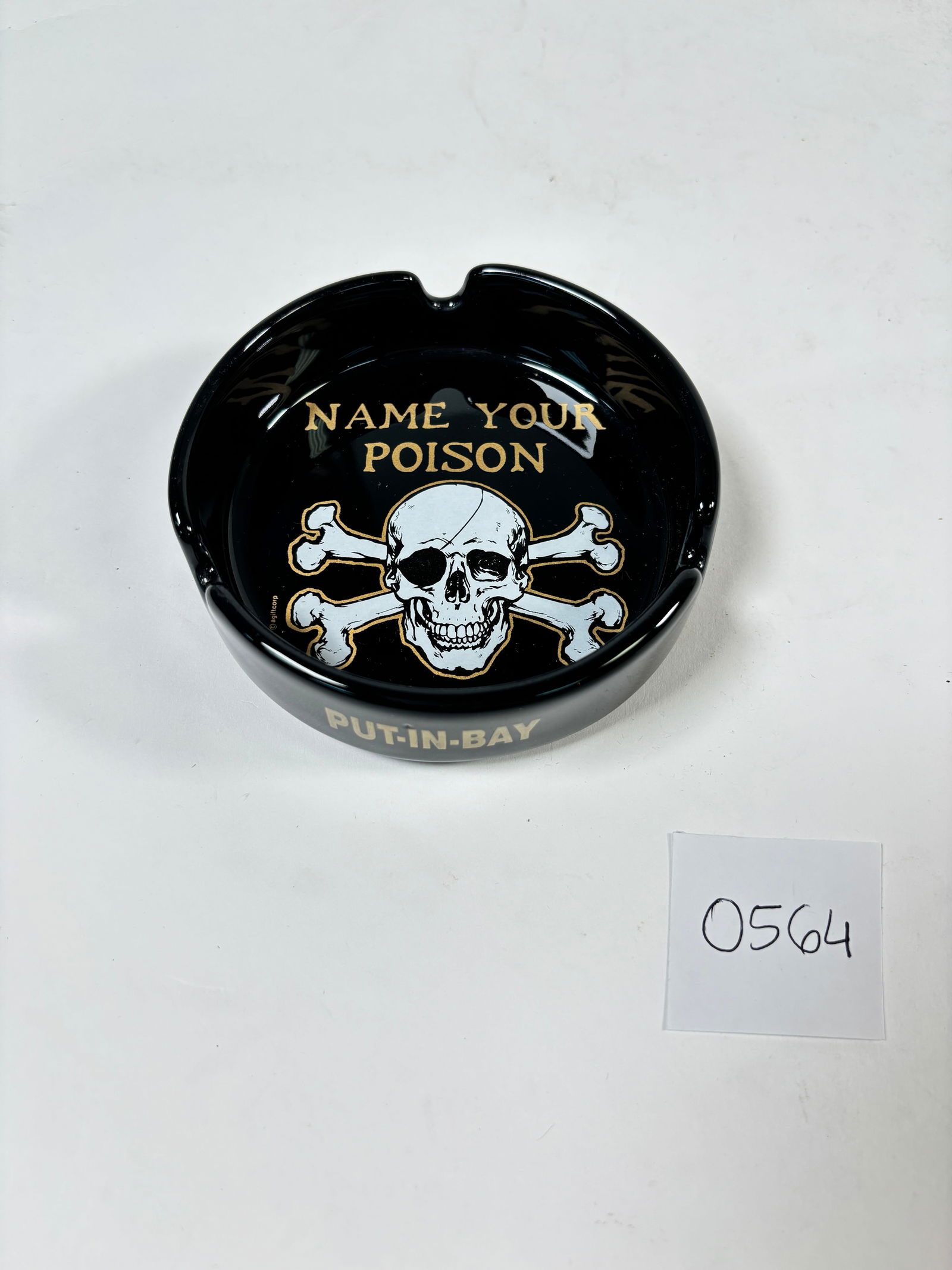 Vintage Black Pirate Ashtray "Name Your Poison": A unique vintage ashtray featuring a black pirate design with the phrase "Name Your Poison." Perfect for collectors of nautical or whimsical memorabilia, this ashtray adds a fun, quirky touch to any s