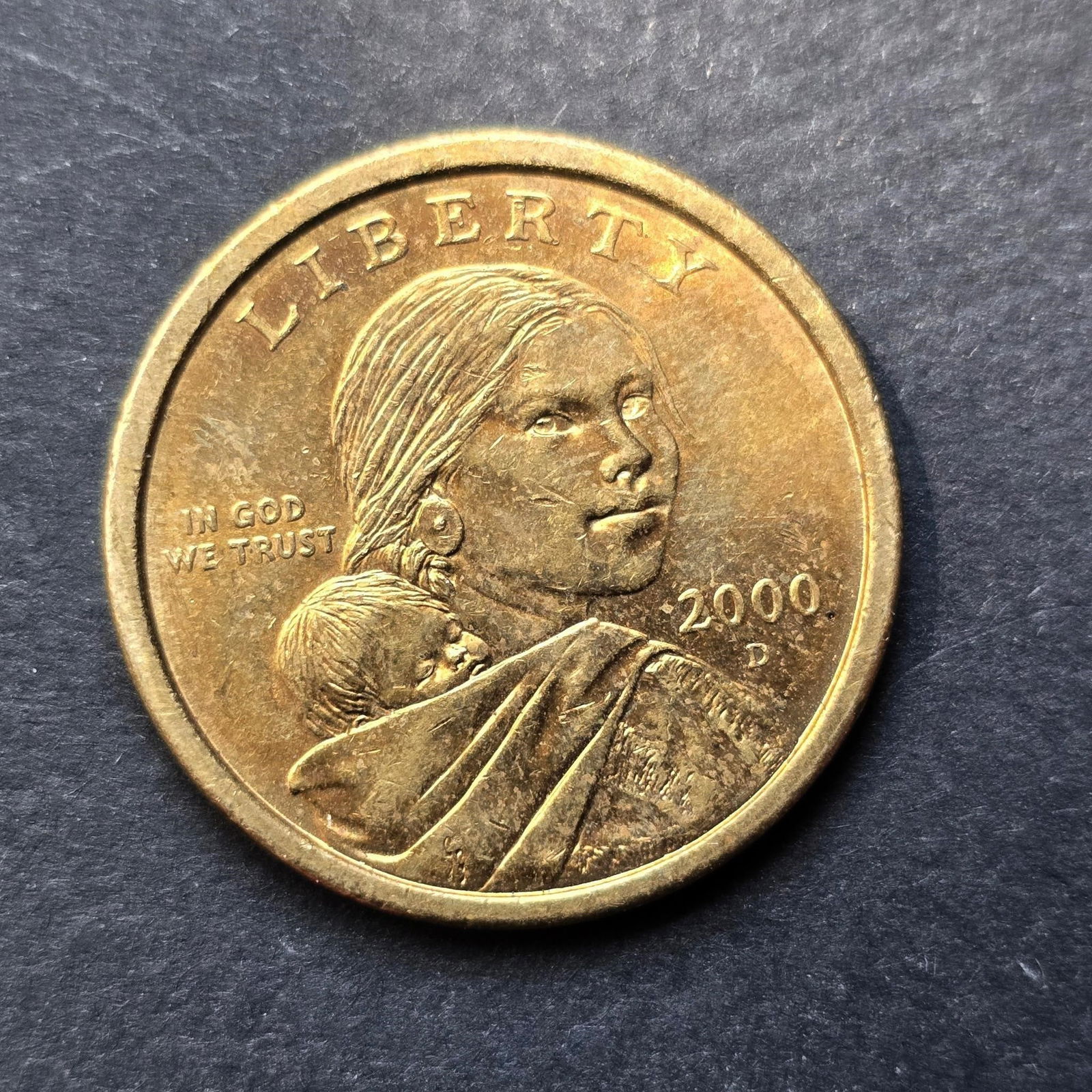 2000-D Sacagawea Dollar Coin - U.S. Mint Denver: Offered here is a 2000-D Sacagawea Dollar, struck at the Denver Mint. This historically significant coin features Sacagawea carrying her infant son, Jean Baptiste, on the obverse-a tribute to her vita