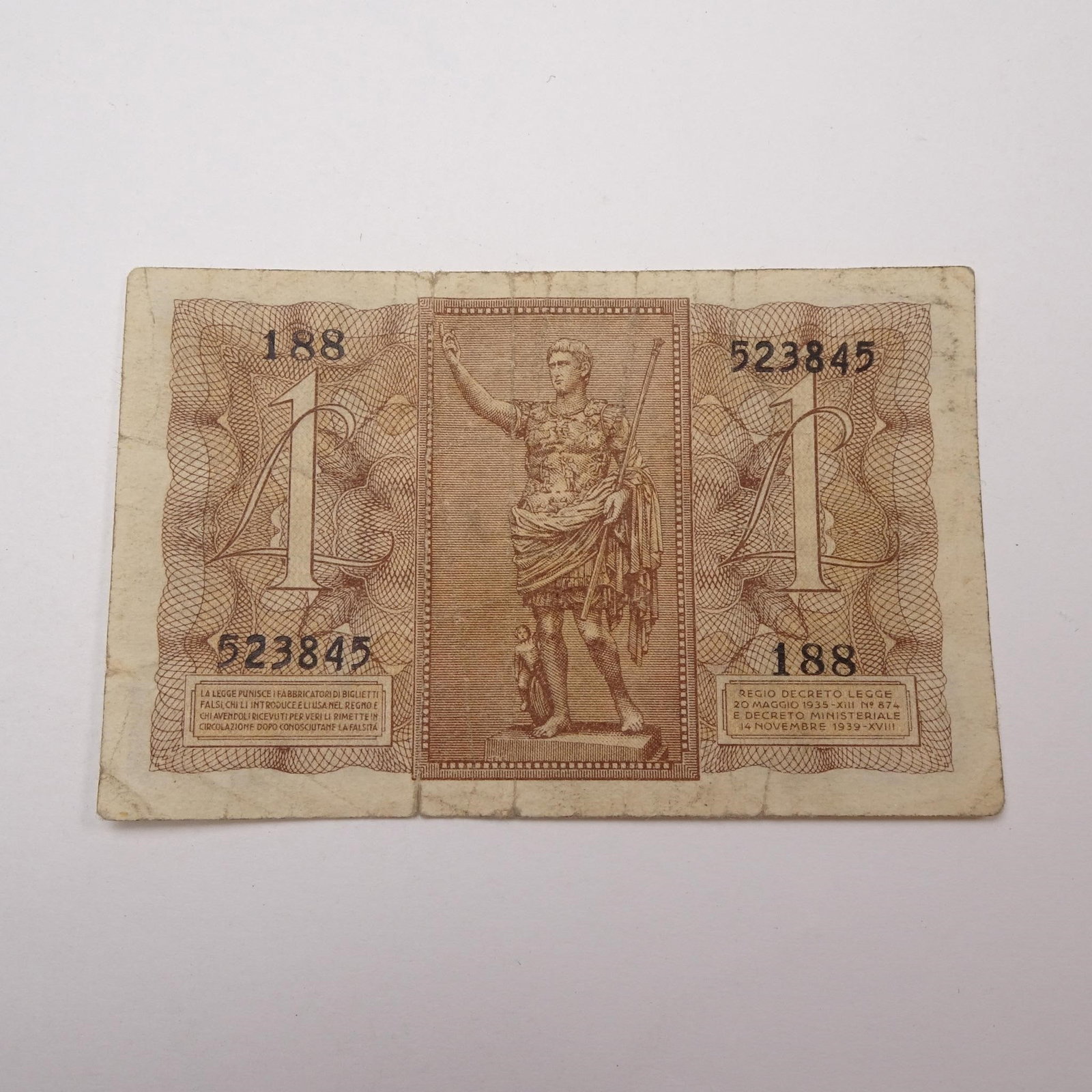 Italy - 1 Lira - 1939:: This WWII-era 1 Lira banknote from 1939 offers a glimpse into Italy's wartime currency, issued just prior to and during the early years of the conflict. A historically significant piece for collectors