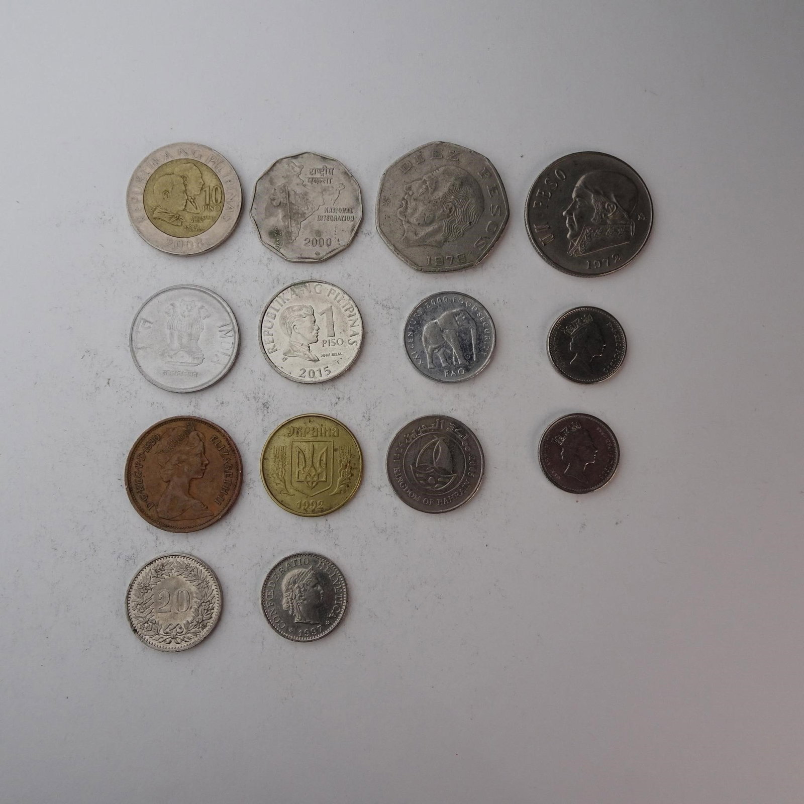 Diverse Assortemnt of International Coins Set...: of International Coins Set of 14 (UK, India, Philipinas, and more). Diverse collection perfect for starting a collection, filling gaps, or for educational purposes. Years and mint marks included in th