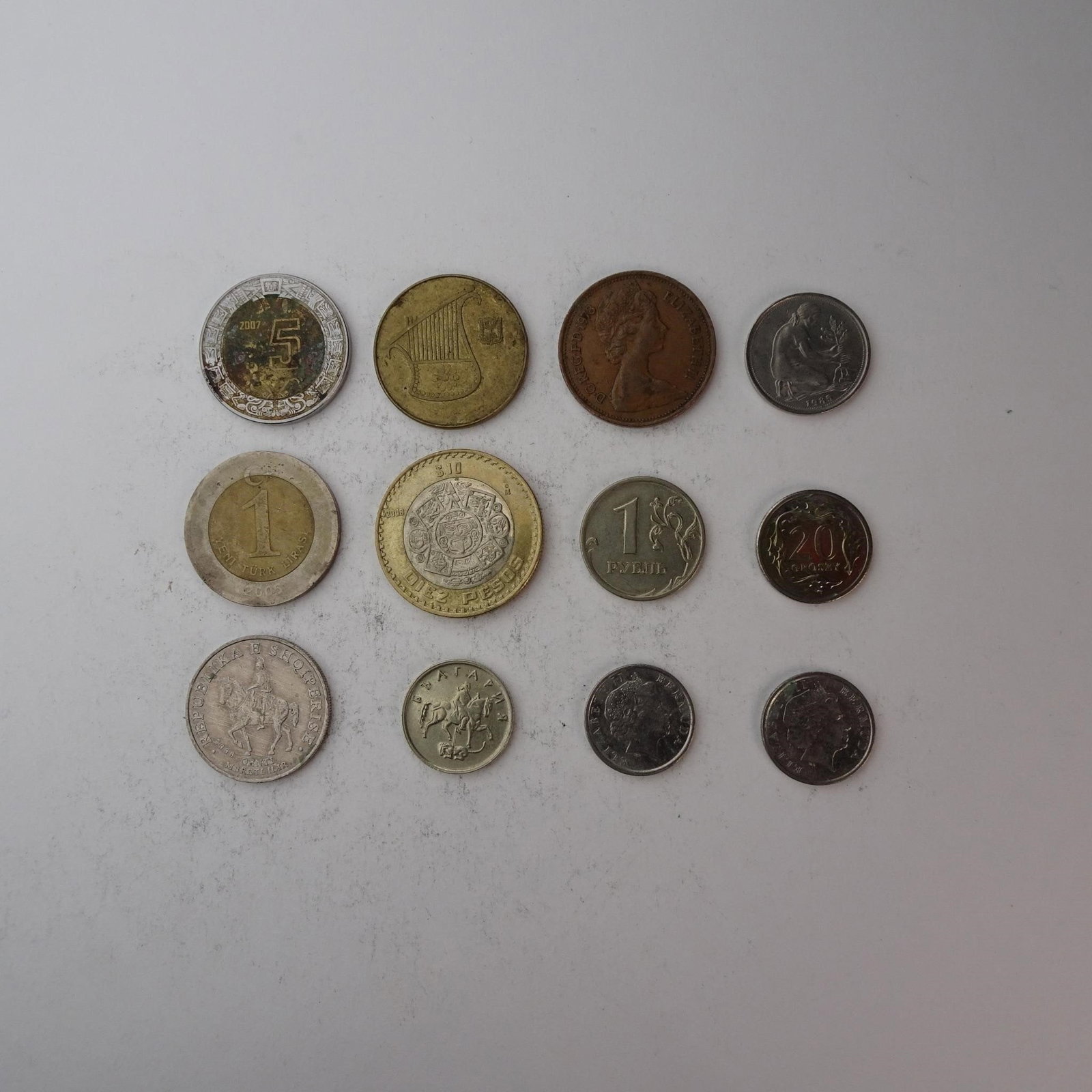 Diverse Assortemnt of International Coins Set...: of International Coins Set of 12 (Albania, Mexico, UK and more). Diverse collection perfect for starting a collection, filling gaps, or for educational purposes. Years and mint marks included in the s