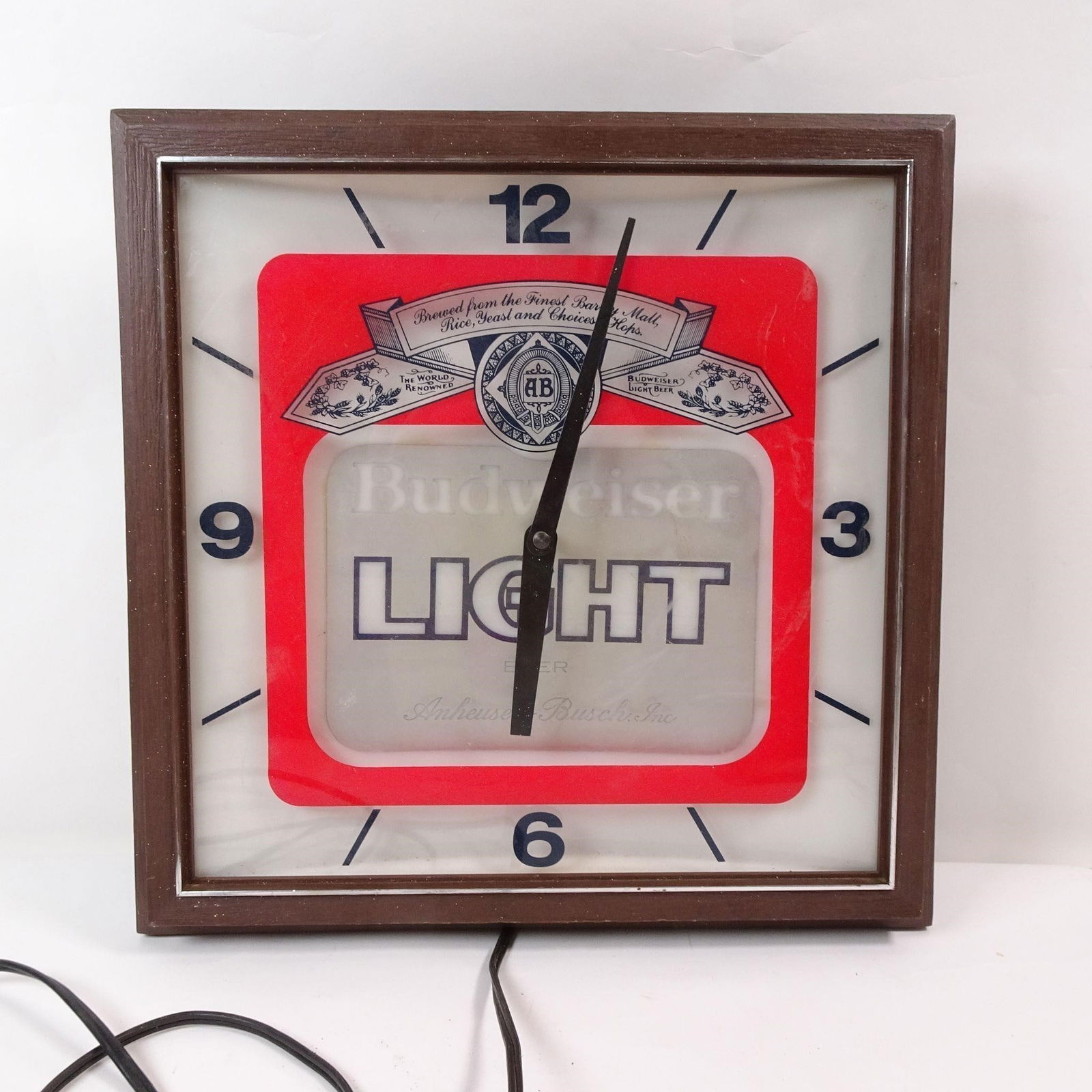 Vintage Light Up Budweiser 'Light' Clock: A vintage light-up clock featuring the iconic Budweiser 'Light' logo. This classic piece of breweriana is perfect for adding a touch of nostalgic pub charm and a retro glow to any bar, game room, or m