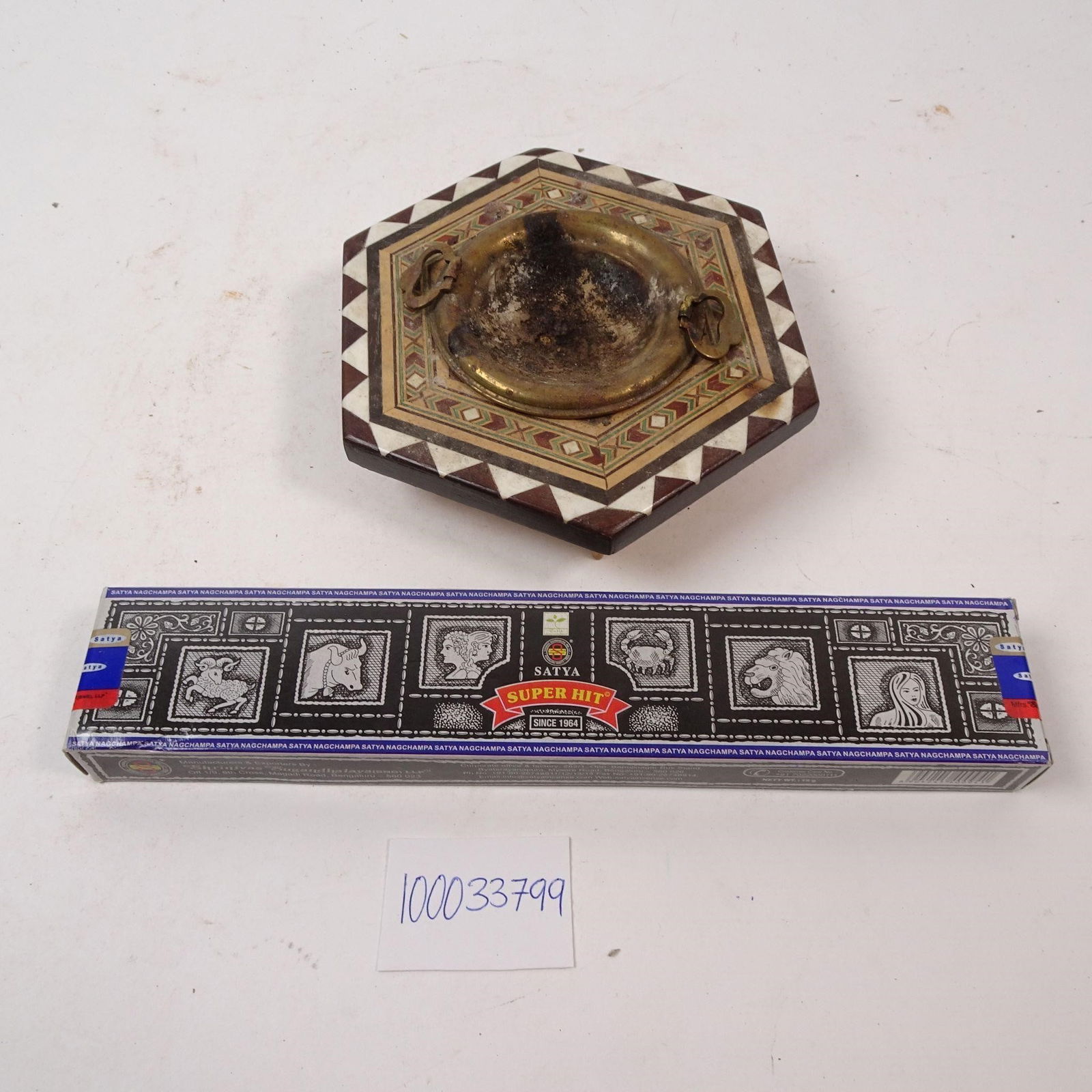 Vintage Marquetry Ashtray, Incense, Tarot Cards: An eclectic collection featuring a vintage marquetry ashtray, incense, and a set of tarot cards. This unique set blends vintage craftsmanship with a touch of the mystical, perfect for creating a cozy,