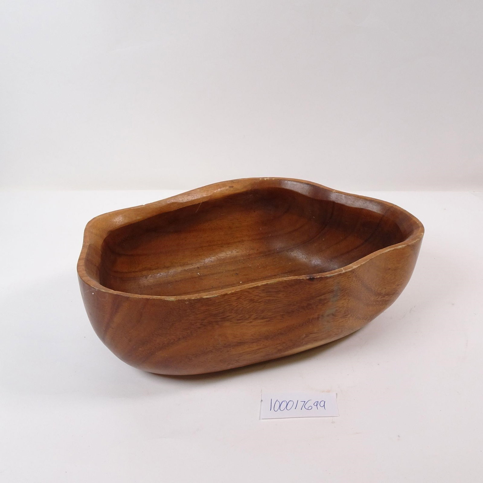 Wooden Organically Shaped Decorative Bowl: A decorative bowl crafted from natural wood, perfect for adding a touch of rustic charm to any space. This versatile piece can be used as a centerpiece or to hold keys, potpourri, or other small items