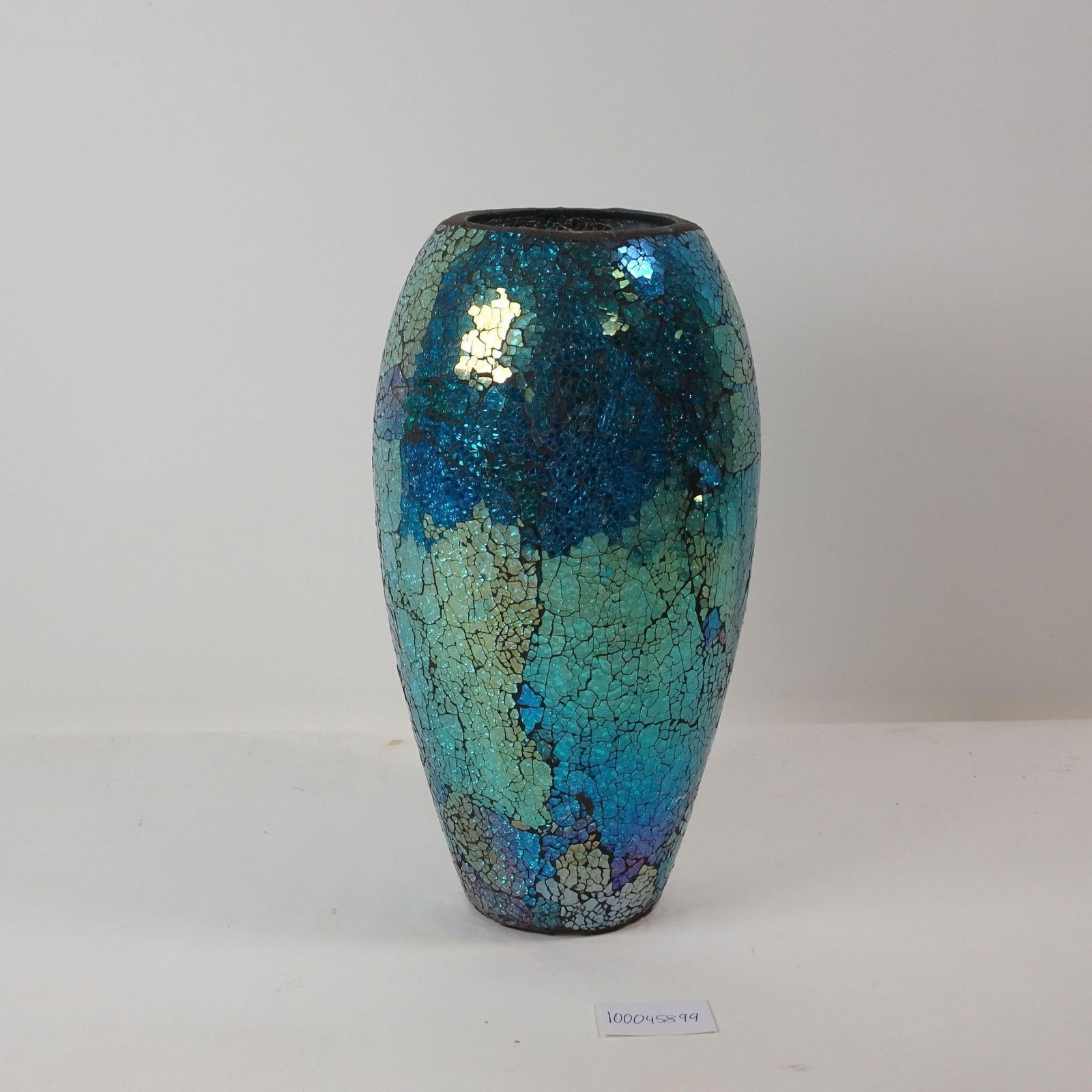 Ceramic Blue Mosaic Vase: A decorative ceramic vase featuring a striking blue mosaic design. This unique piece is perfect for adding a touch of sophisticated color and intricate texture, ideal for displaying a fresh bouquet or