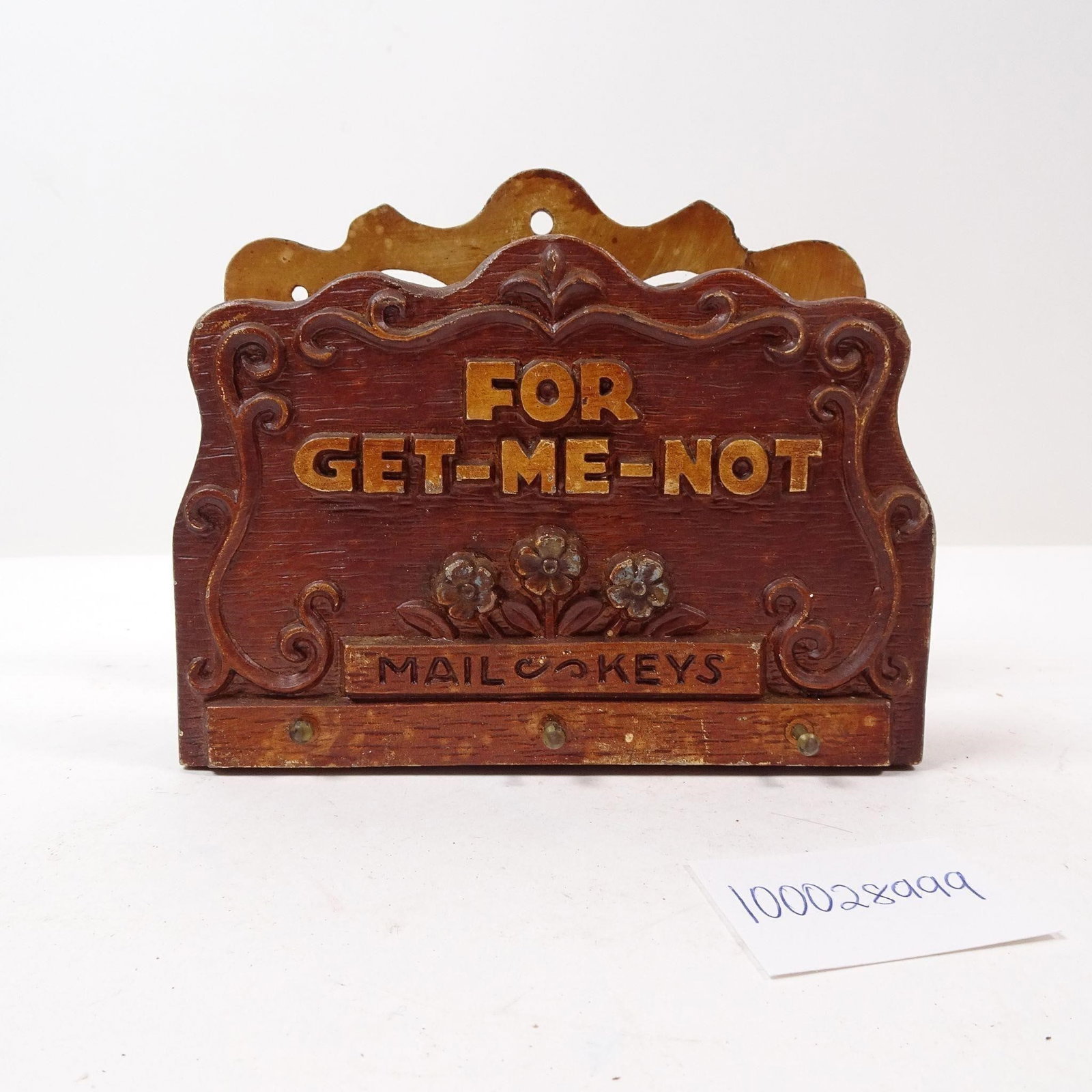 Vintage Wooden For Get-Me-Not Mailholder: A charming vintage wooden mail holder featuring the playful inscription 'For Get-Me-Not'. This unique piece is perfect for adding a touch of rustic warmth and nostalgic character to your entryway or o
