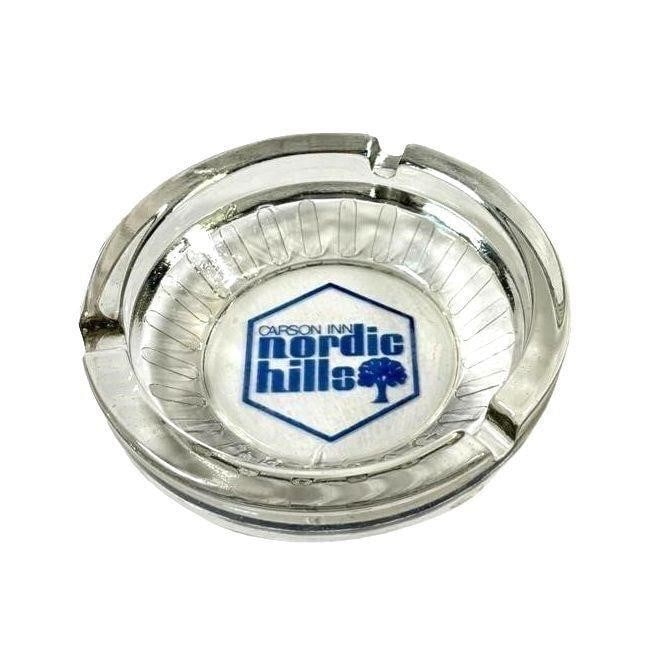 Vintage Carson Inn Nordic Hills Glass Ashtray: Vintage Carson Inn Nordic Hills Glass Ashtray A collectible glass ashtray featuring the Carson Inn branding. A great addition for vintage hospitality memorabilia collectors or as a unique decorative p