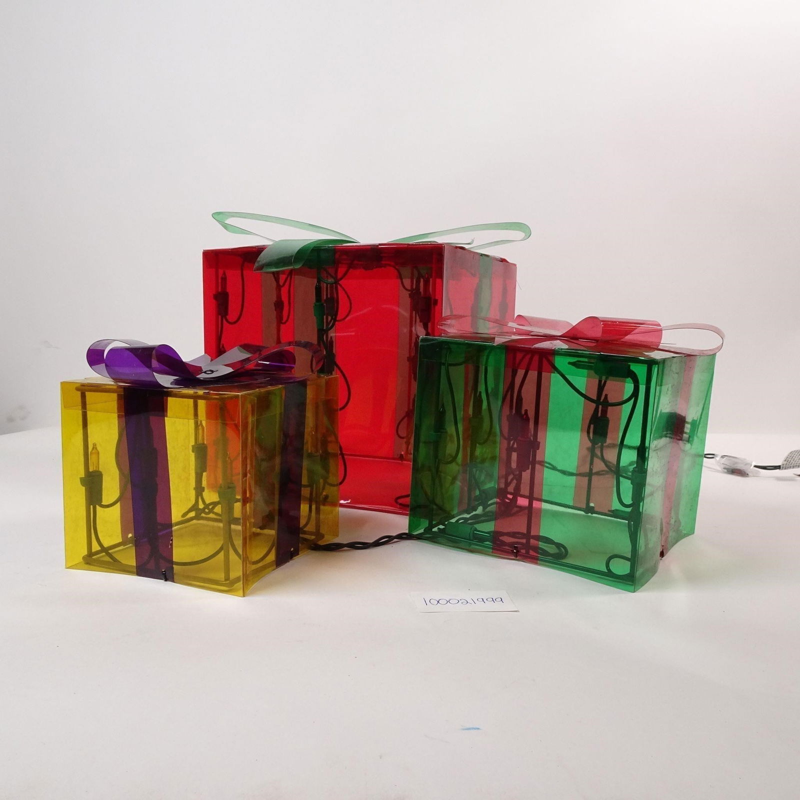 Lighted Gift Boxes Set of 3 Christmas Decor: A set of three lighted gift boxes, perfect for adding a festive glow to your holiday dcor. These charming decorations are ideal for creating a warm and inviting atmosphere on your porch, under the Chr