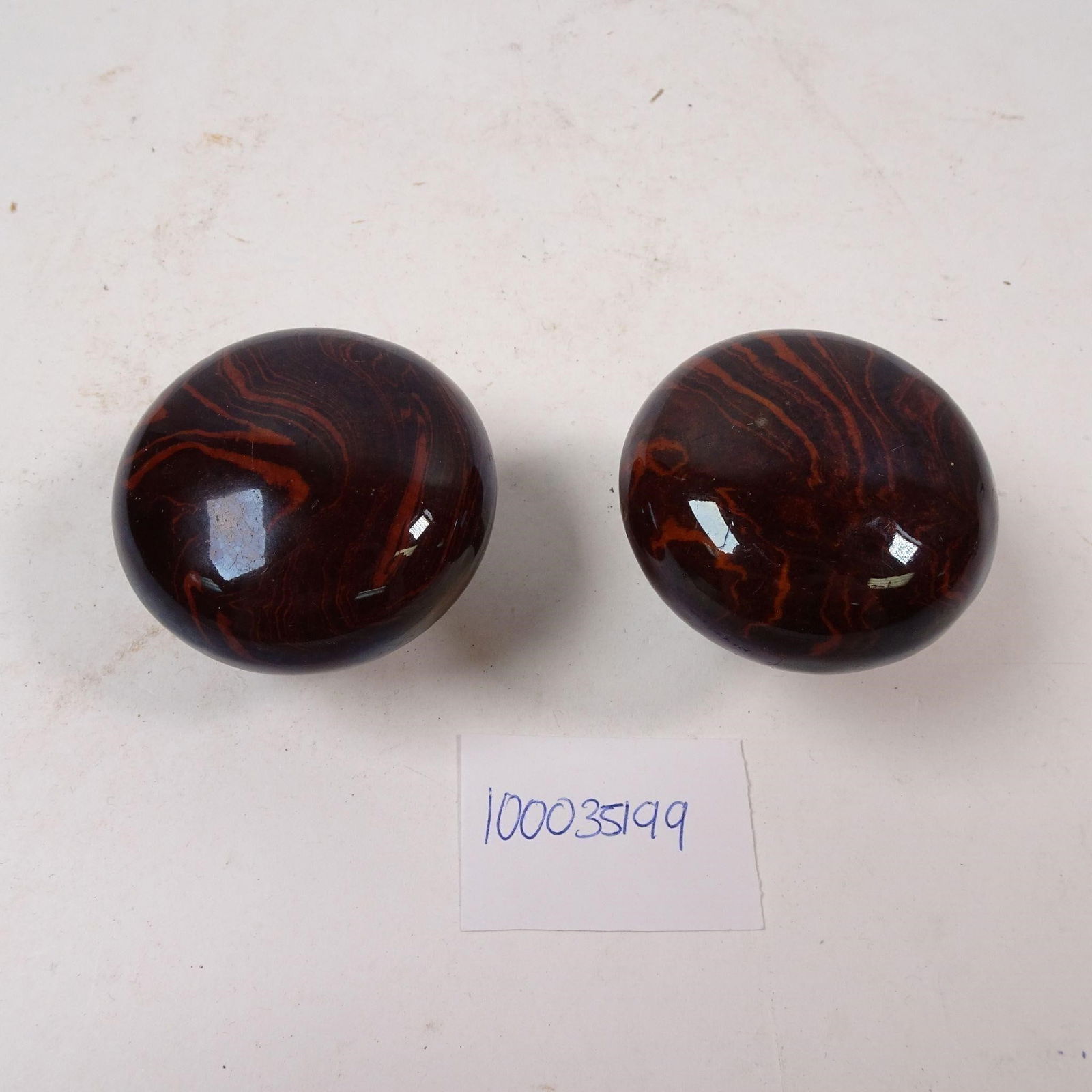 Vintage Ox Blood Red and Black Cabinet Knobs: A set of vintage cabinet knobs featuring a striking Ox Blood Red and Black color scheme. These decorative pieces are perfect for updating old furniture or cabinetry, adding a touch of bold, nostalgic