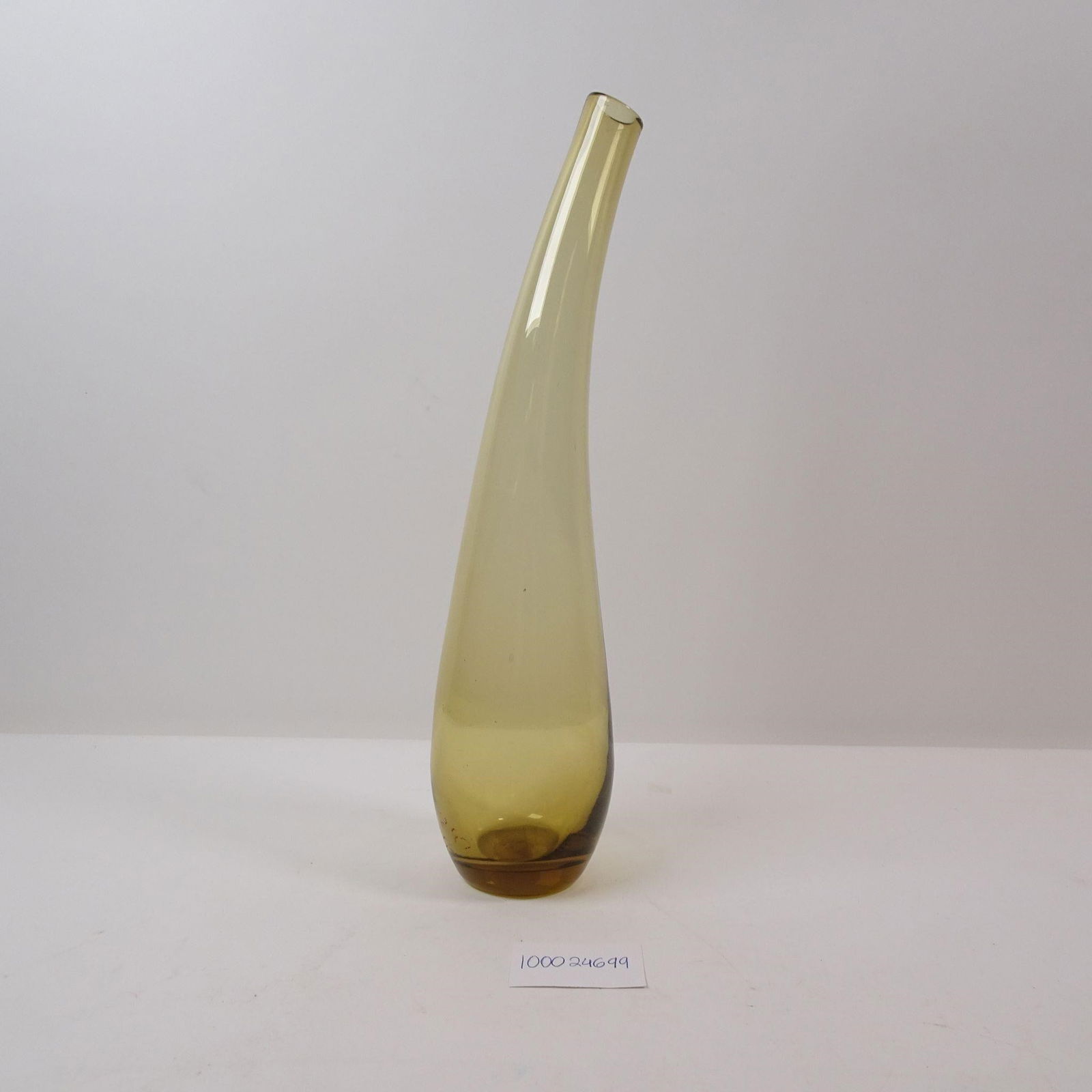 Curved Yellow Glass Vase: A decorative vase crafted from elegant yellow glass with a unique curved design. This piece adds a vibrant and modern touch of color, perfect for displaying a bouquet or as a striking standalone accen