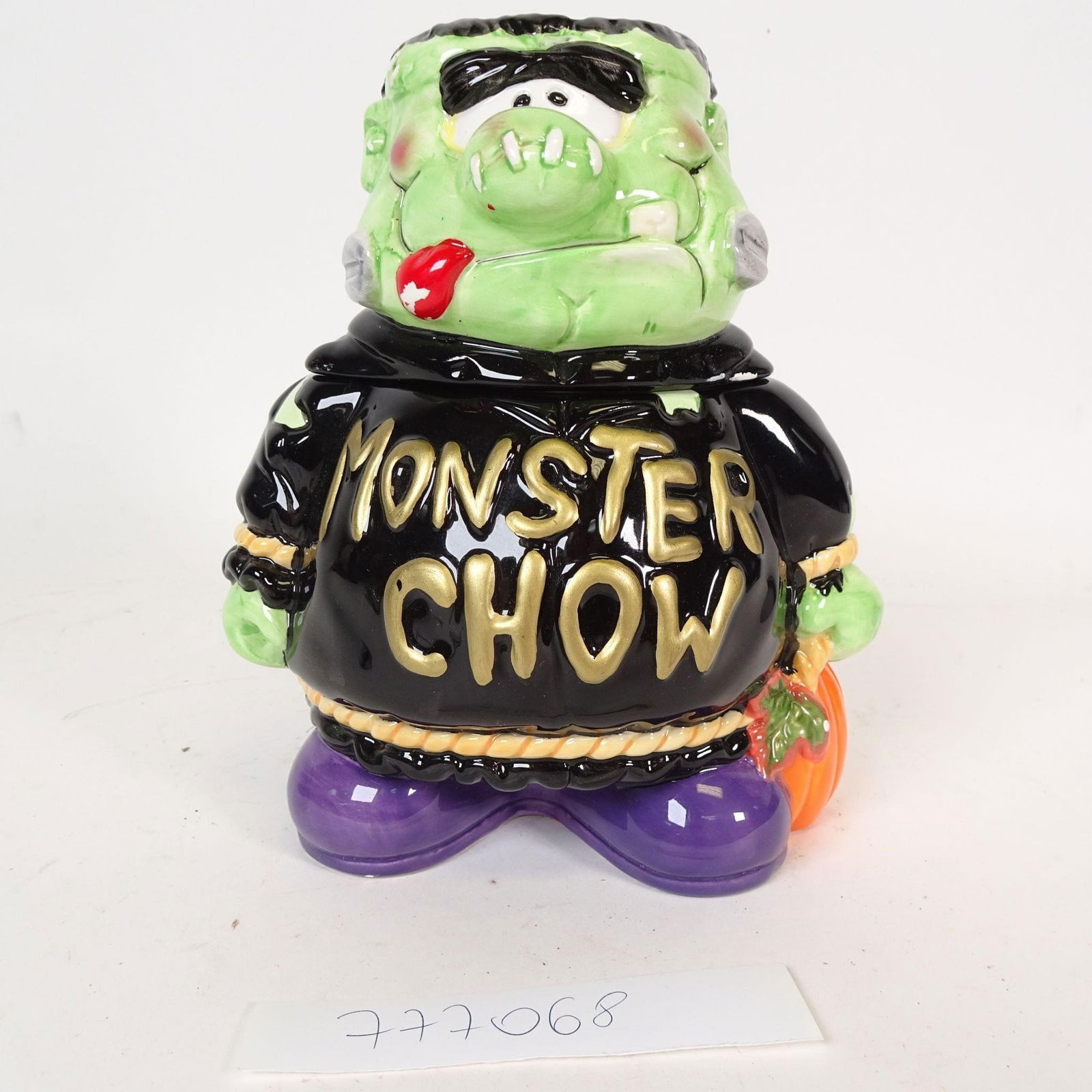 Monster Chow Cookie Jar: Fun Halloween ceramic cookie jar featuring a Frankenstein-style monster with removable head lid.Bold colors, glossy finish, and "Monster Chow" lettering on front.Great for Halloween décor, kitchen di