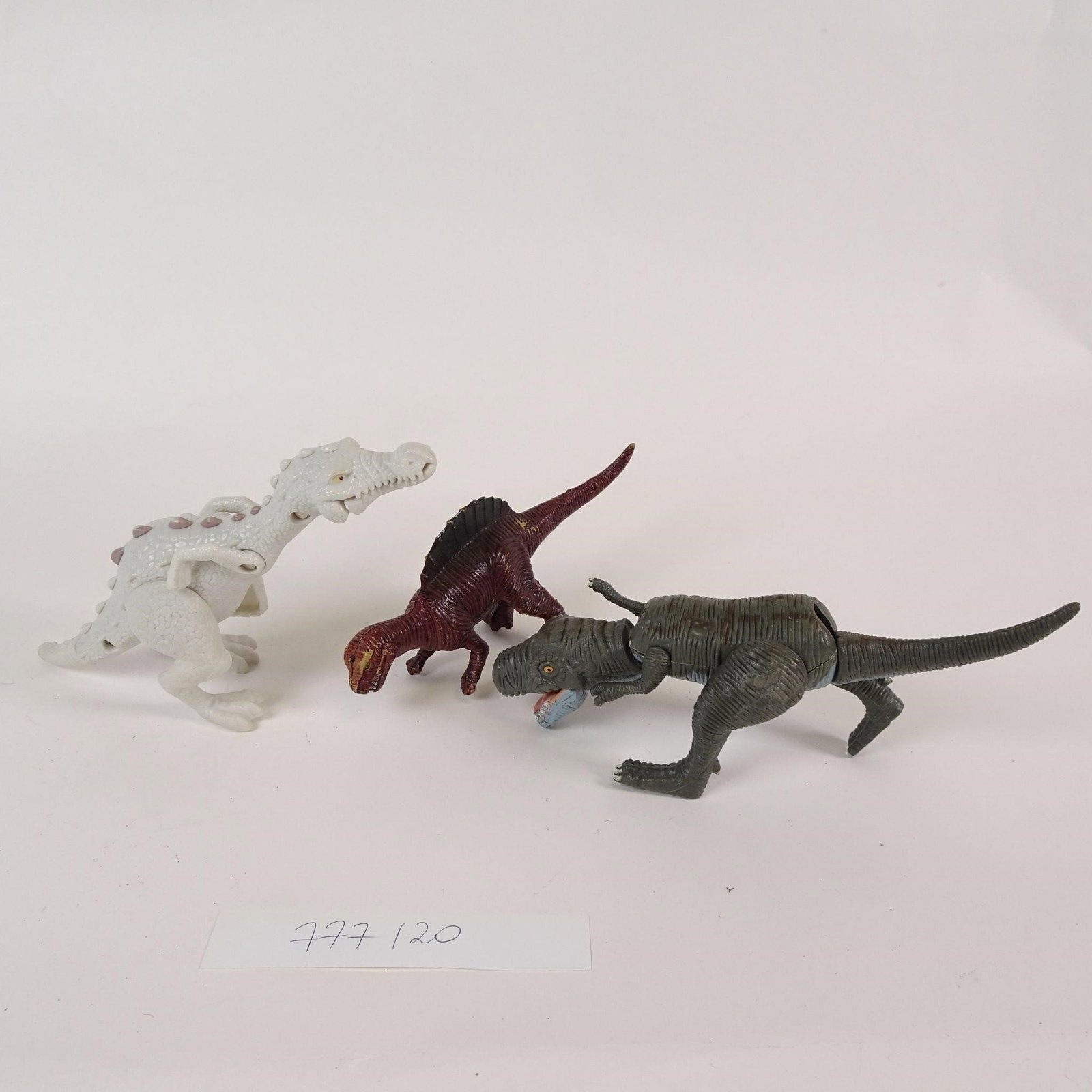 Vintage Style Dinosaur Toy Figures Lot: Lot of 3 dinosaur toy figures made of hard plastic.Includes different dinosaur styles and colors.Pre-owned condition with surface wear, scratches, and paint wear from age and play.Sold as a lot.