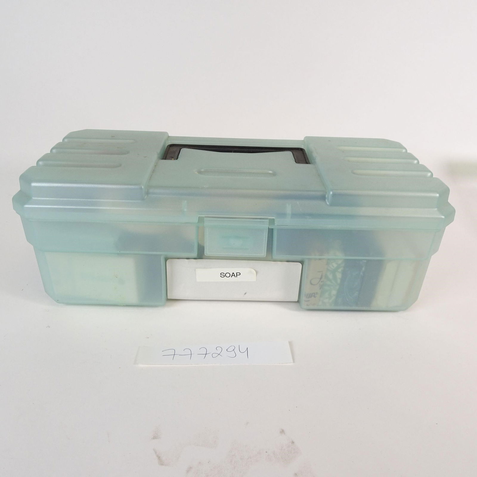 Vintage Travel Soap & Toiletries Lot: Offered as one mixed lot is a vintage collection of soaps and hotel toiletries, stored in a plastic organizer box labeled "SOAP." This lot includes a variety of unused or partially used items collecte