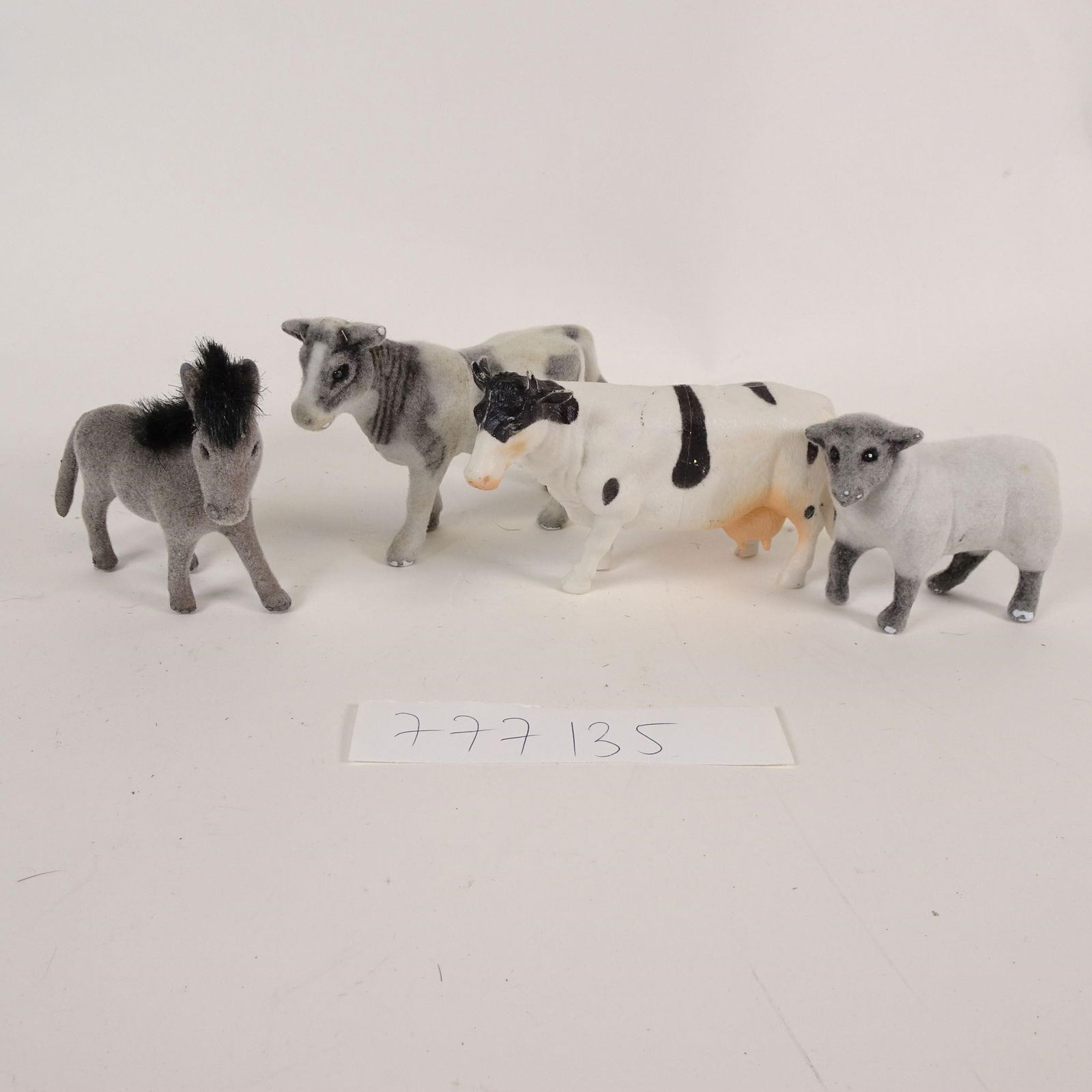 Vintage Flocked Farm Animals Toy Figures: Vintage lot of flocked farm animal toy figures. The set includes a donkey, a cow, and sheep figures, made of molded plastic with flocked (felt-like) surface. Typical mid-20th century children's toys,