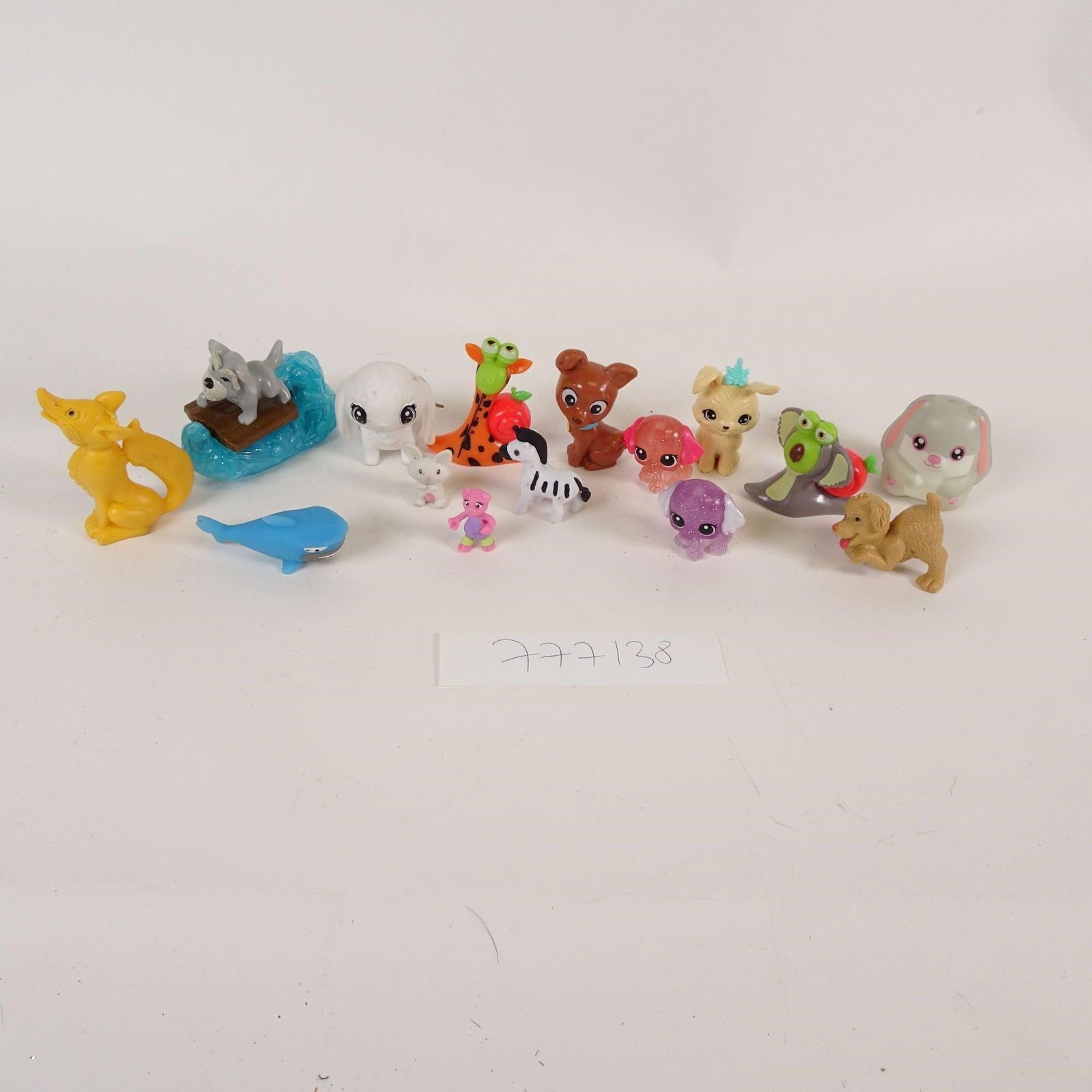 Mixed Lot of Small Plastic Toy Figures: A mixed lot of small plastic toy figurines featuring a variety of animals and fantasy-style characters. Includes dogs, rabbits, giraffe, snail, sea creatures, cartoon-style figures, and other assorted