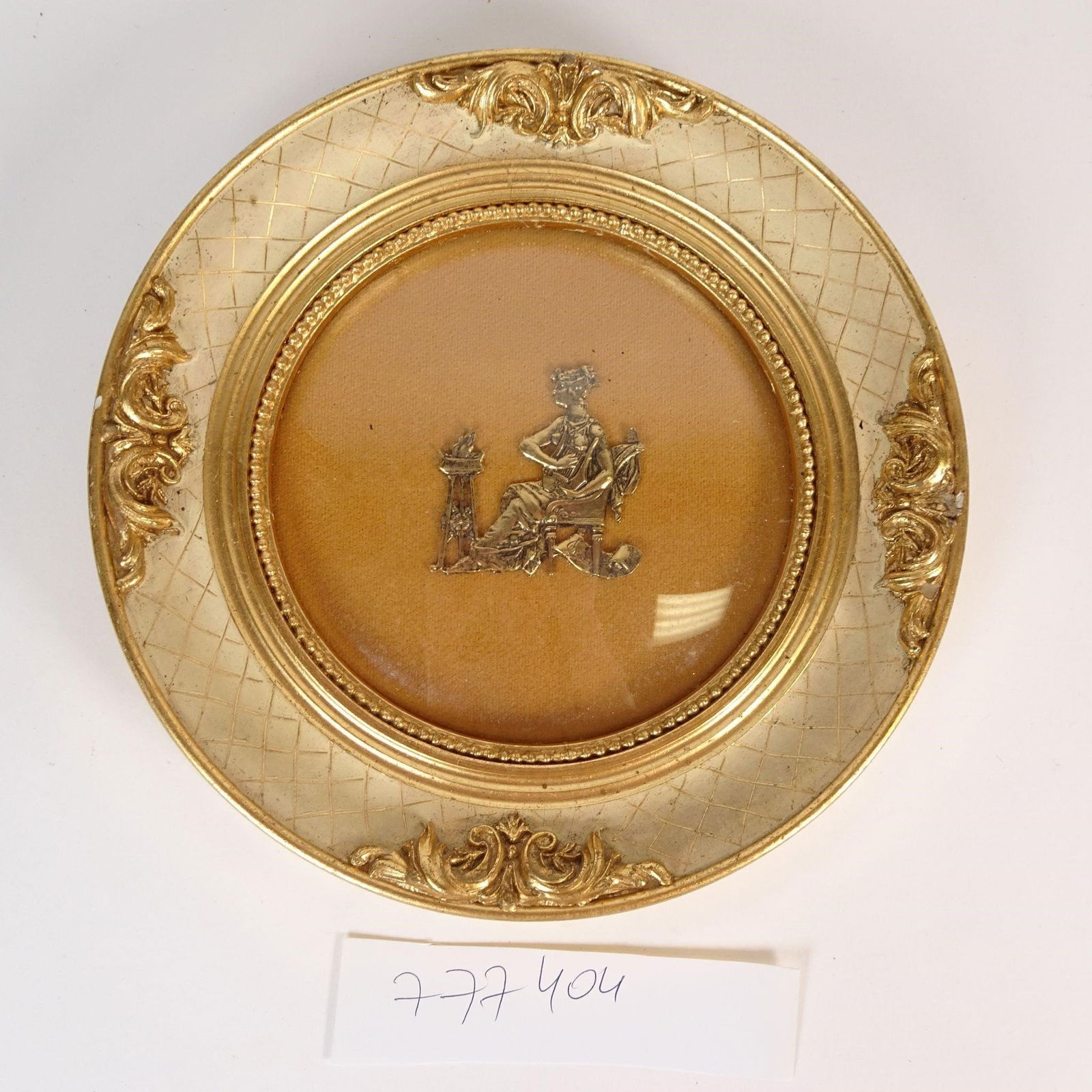 Antique Round Decorative Frame with Metal Relief: Antique round decorative wall frame featuring ornate gilt-style detailing and a central metal relief depicting a classical figure in neoclassical style. Produced by the well-known New York frame maker