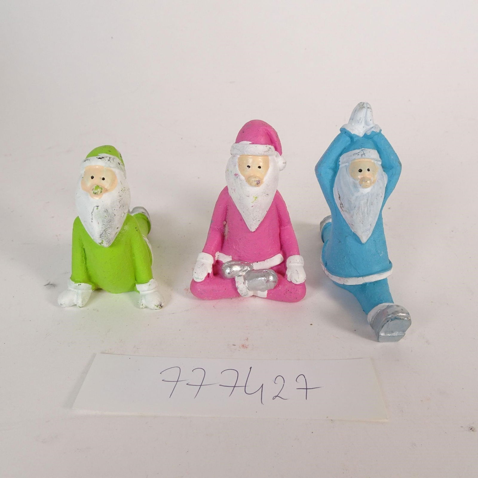 Set of 3 Santa Claus Figurines: Set of three decorative Santa Claus figurines in fun yoga / stretching poses. Each figure is in a different color (green, pink, blue) and a unique pose. You will receive exactly the items shown in the