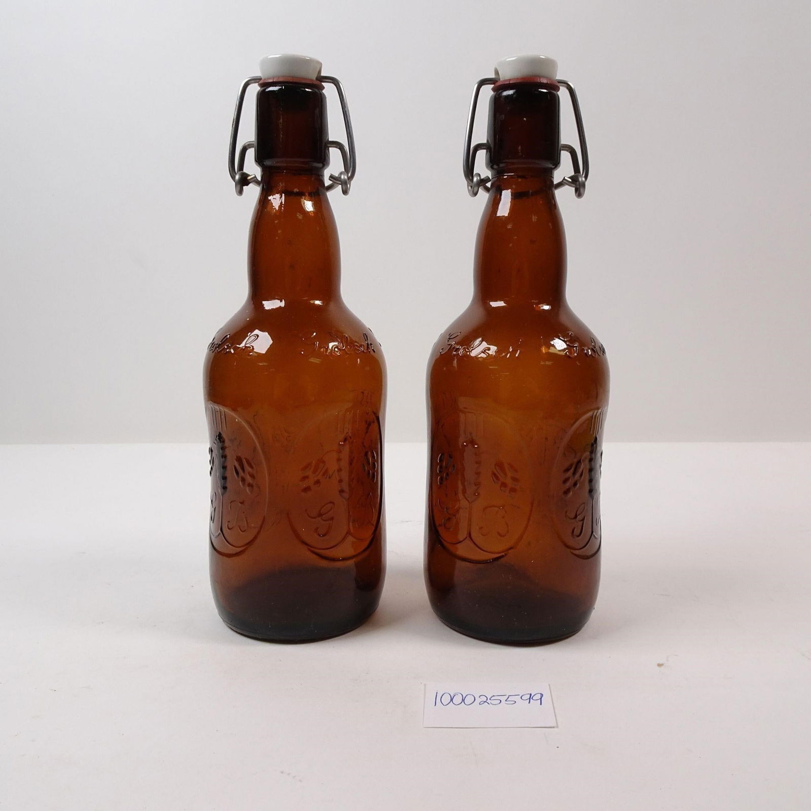 Grolsch Georgia Brown Cork swing Bottle Set of 2: A set of two iconic Grolsch beer bottles from the Georgia Brown variety, featuring the classic swing-top cork. These collectible bottles are perfect for home brewers or for adding a touch of classic b