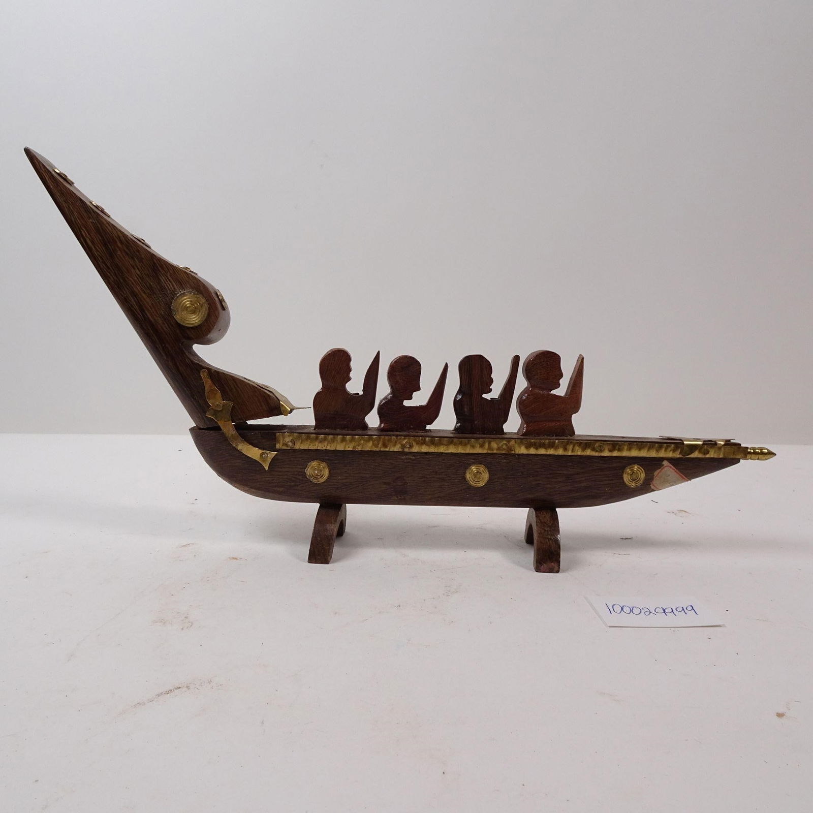 Wood and Brass Viking Ship Warriors Rowing Model: A decorative model of a Viking ship featuring warriors rowing, crafted from wood and brass. This striking piece is perfect for adding a touch of nautical history and mythological grandeur to a bookshe
