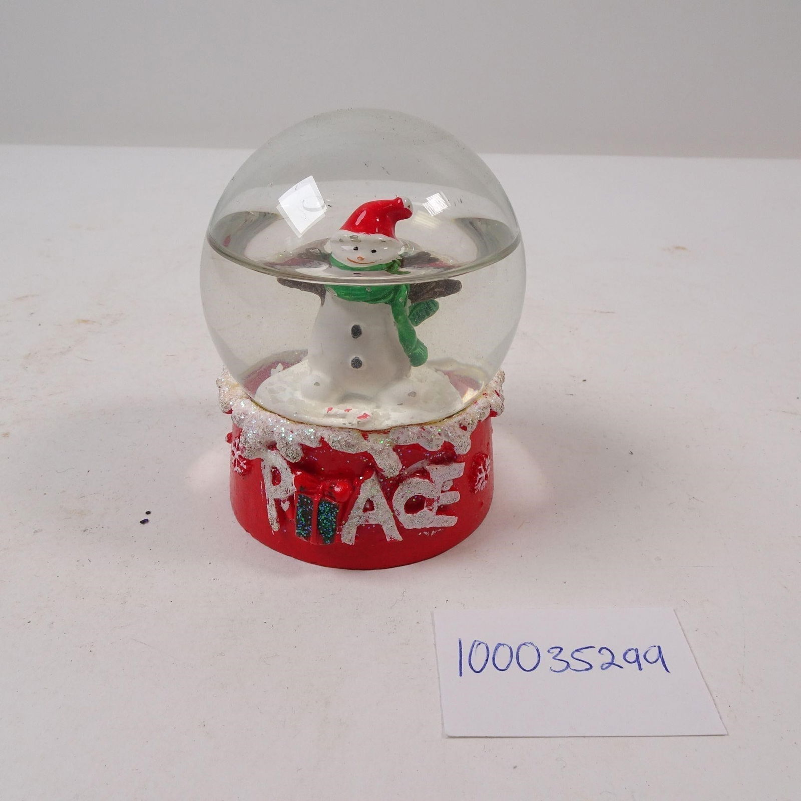 Vtg Small Christmas Snowman Snow Globe: A decorative small Christmas snowman snow globe, perfect for adding a touch of festive magic to your holiday decor. This charming piece is ideal for a desk, mantelpiece, or as a whimsical gift to cele