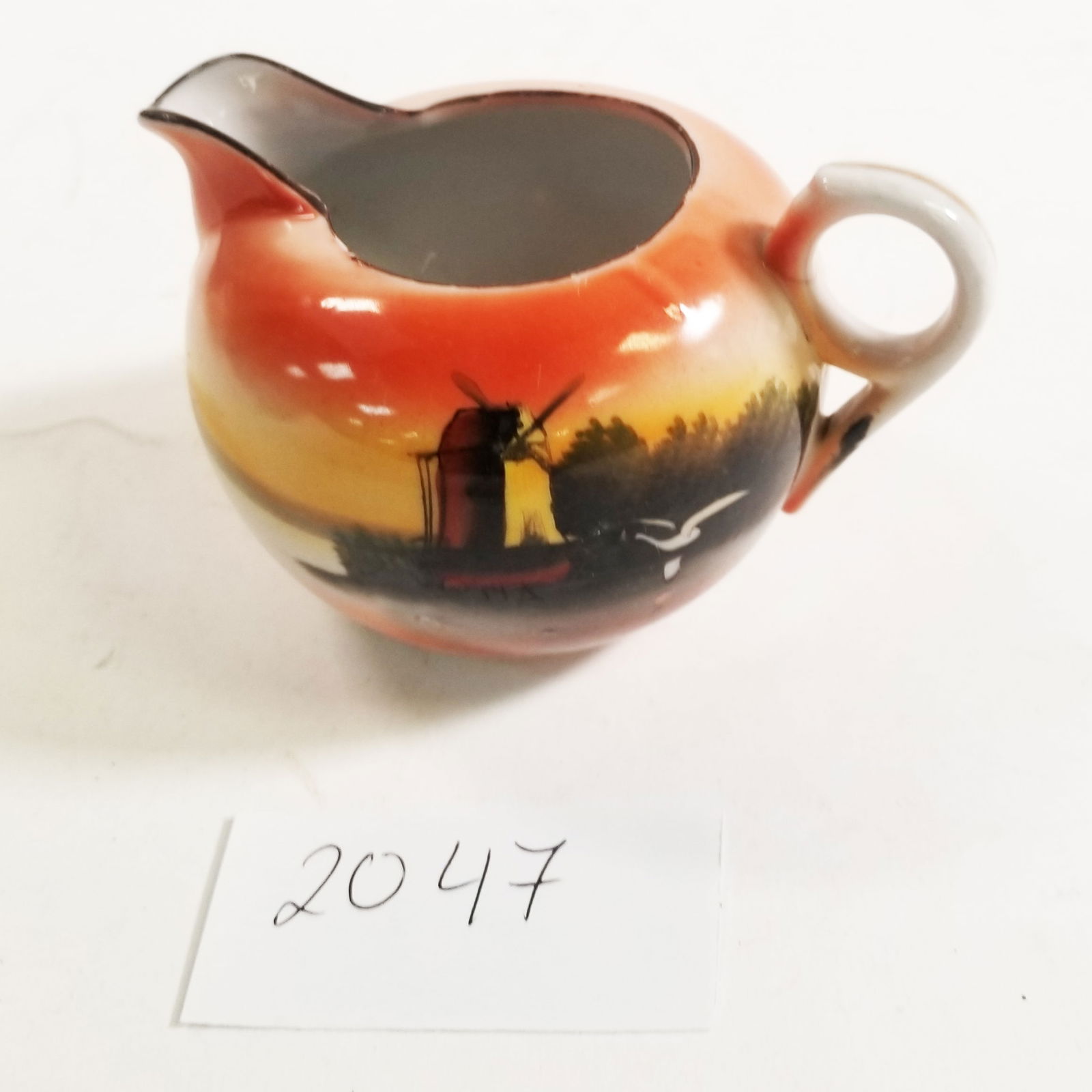 Vintage Japanese Lusterware Creamer with Windmill Scene: A classic Japanese lusterware creamer showcasing a vibrant orange-to-black gradient glaze and charming windmill design. Marked â??Made in Japan” on the base, it likely dates to the early- to mi