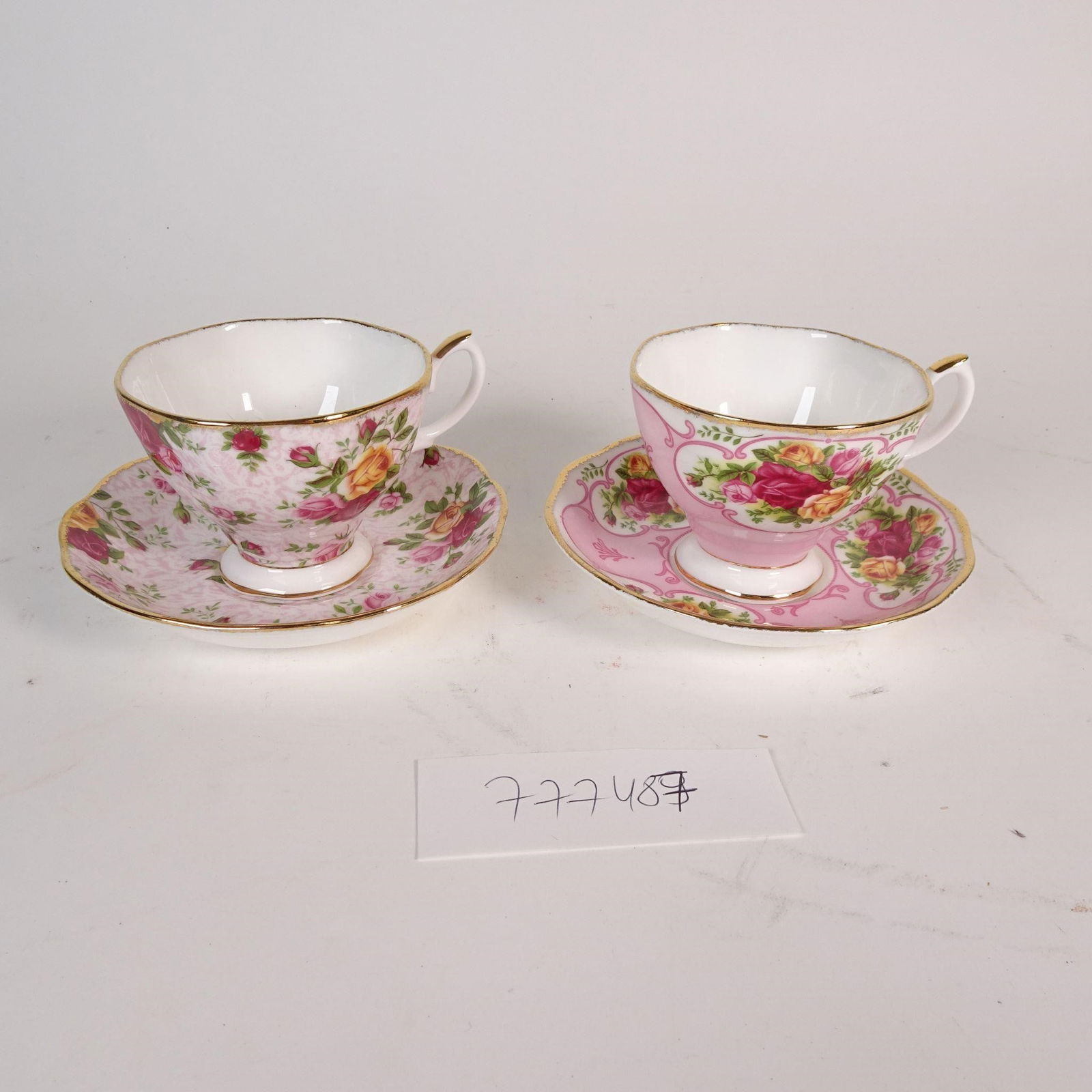 Lot of 2 Royal Albert Teacups & Saucers: Elegant lot of 2 teacups with 2 matching saucers from the Old Country Roses - Soft Pink Lace collection by Royal Albert. Made of fine Bone China, featuring the classic rose floral pattern in soft pink