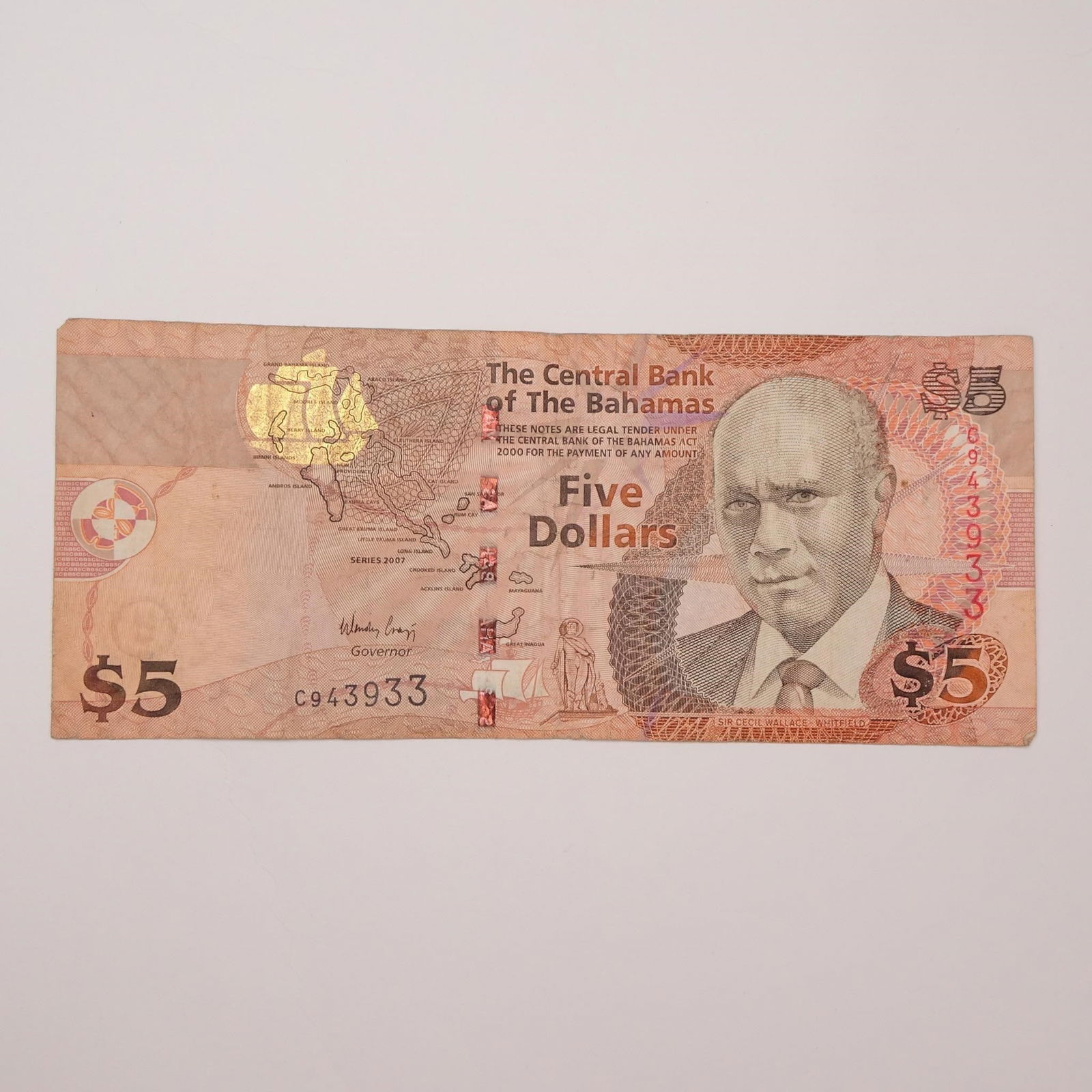 The Bahamas - 5 Dollars - 2007-2013:: This 5 Dollars banknote from The Bahamas, issued 2007-2013, is a colorful piece featuring Sir Cecil Wallace-Whitfield and a vibrant Junkanoo parade scene. It celebrates The Bahamas' rich cultural