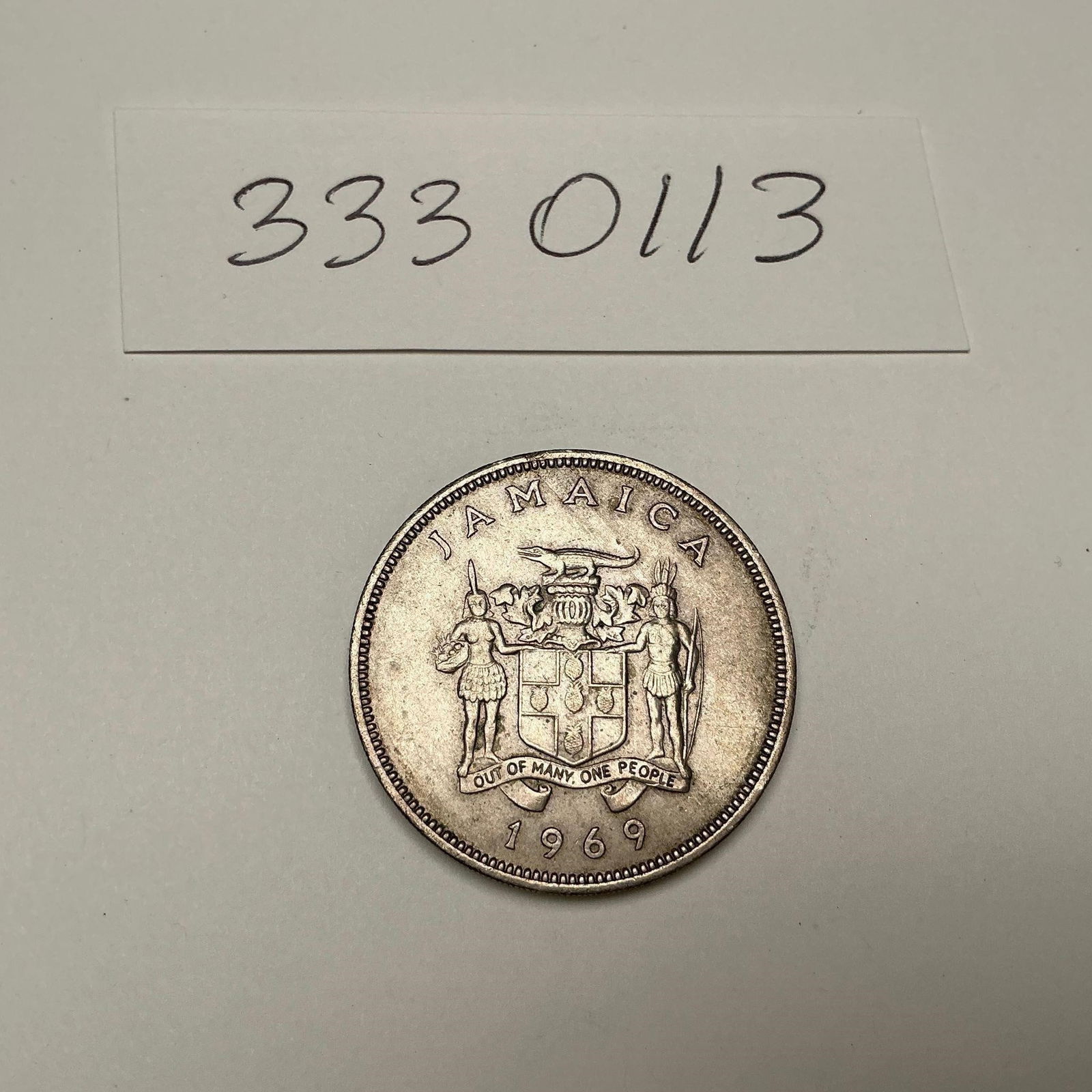 1969 Jamaica 25 Cents Coin: 1969 Jamaica 25 Cents CoinVintage 25 cents coin from Jamaica, dated 1969. Obverse features the coat of arms with the national motto "Out of Many, One People." The reverse depicts a Doctor Bird (swallo