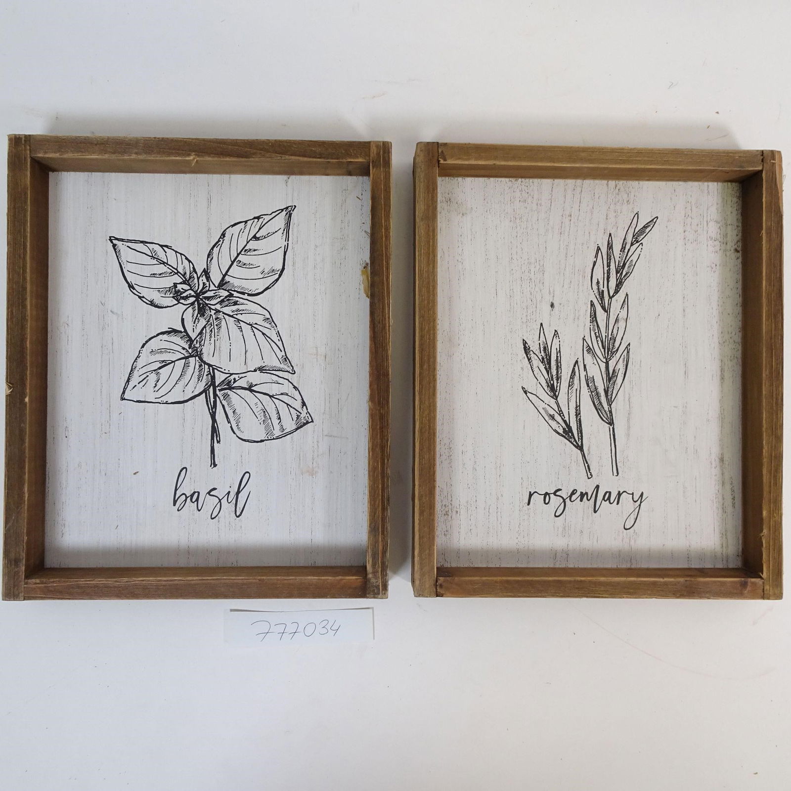 Set of 2 Wall Decor Signs "Basil" & "Rosemary": Charming set of two farmhouse-style wall decor pieces featuring kitchen herbs: Basil and Rosemary. Black and white botanical illustrations displayed in natural wooden frames, perfect for farmhouse, ru