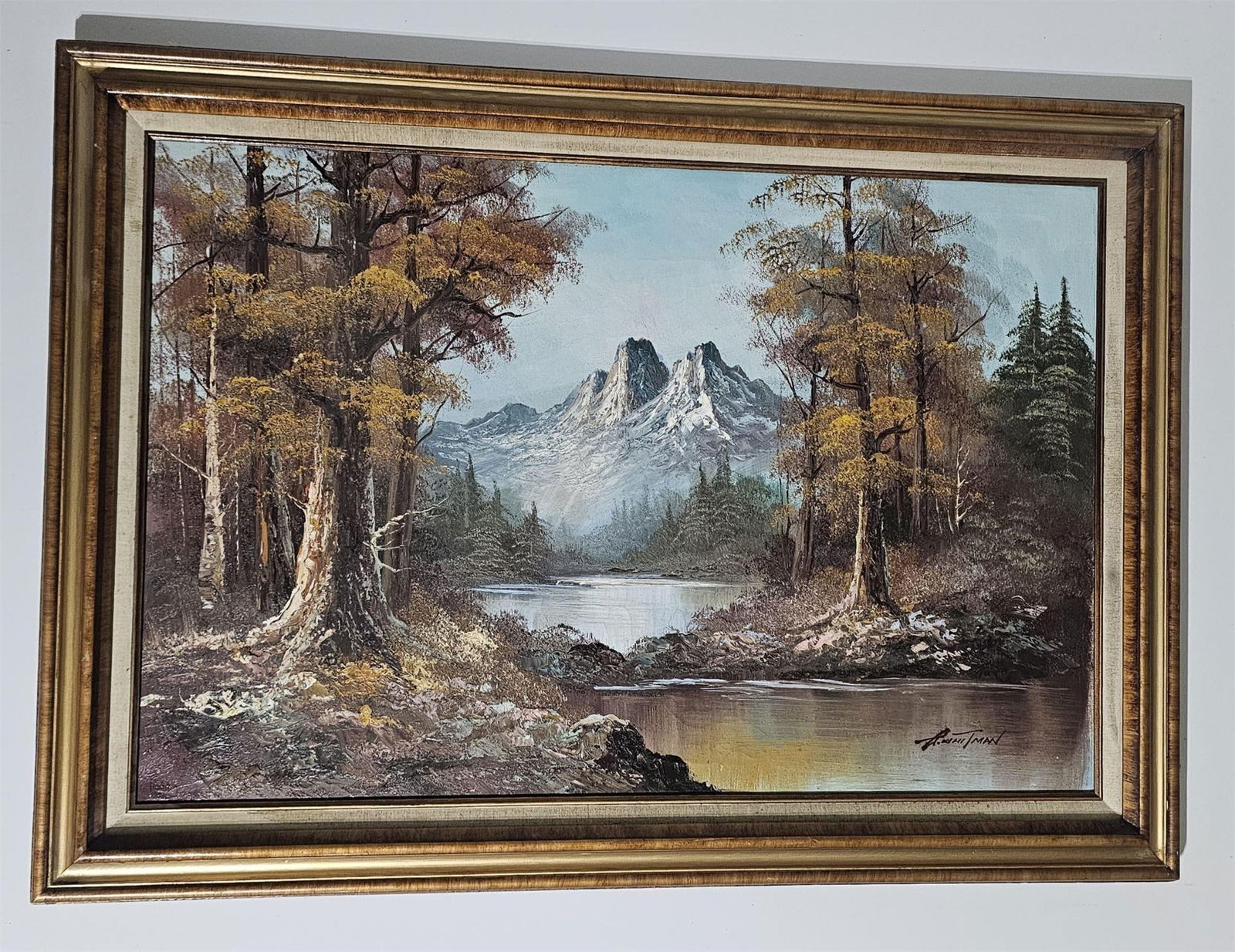 Vintage Mountain Landscape Oil Painting with River: Original vintage oil painting on canvas depicting a serene mountain landscape with a river, trees, and snow-capped peaks in the distance. The composition features natural, earthy tones and reflects cl